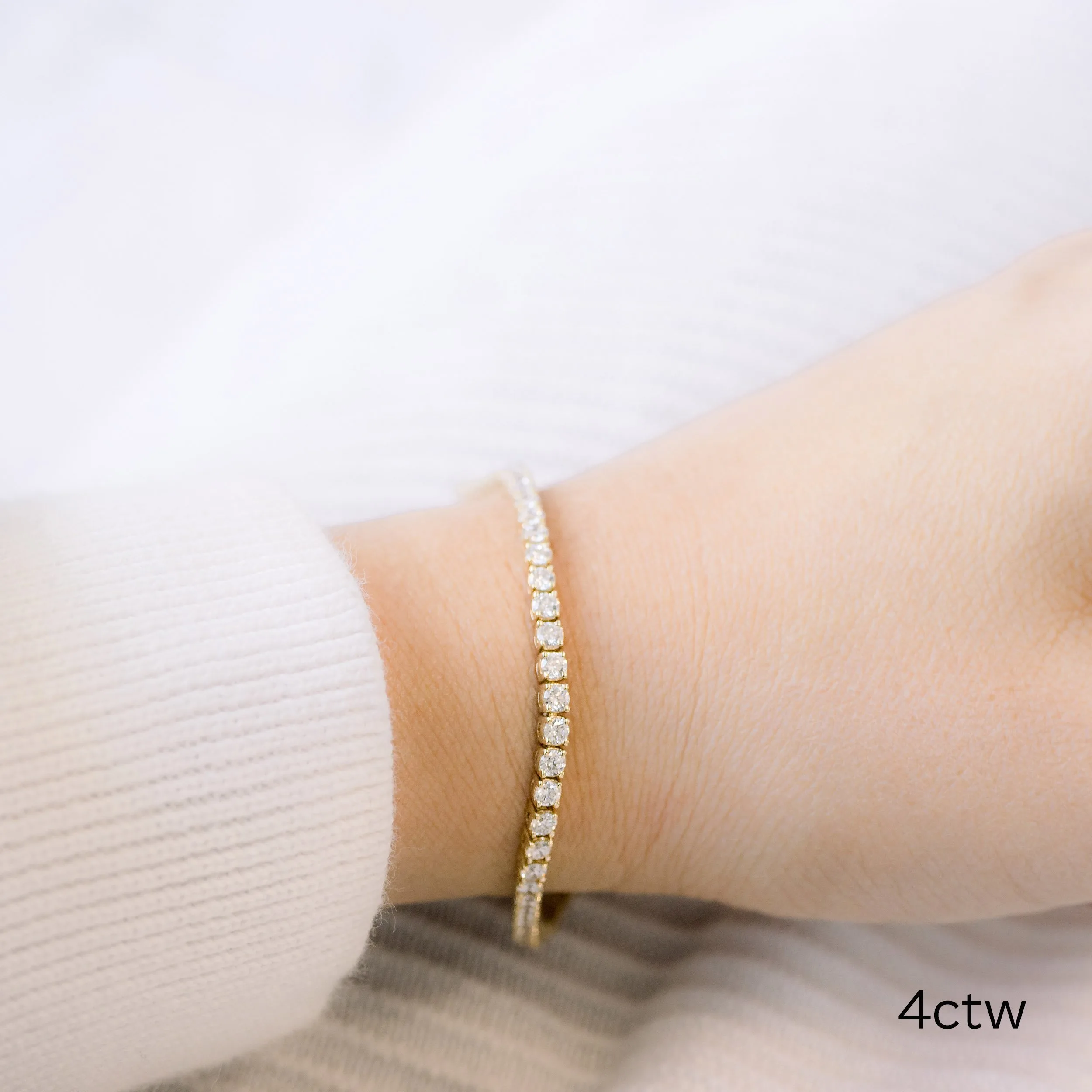 18k gold four carat tennis bracelet featuring manmade diamonds ada diamonds design ad 111 on model