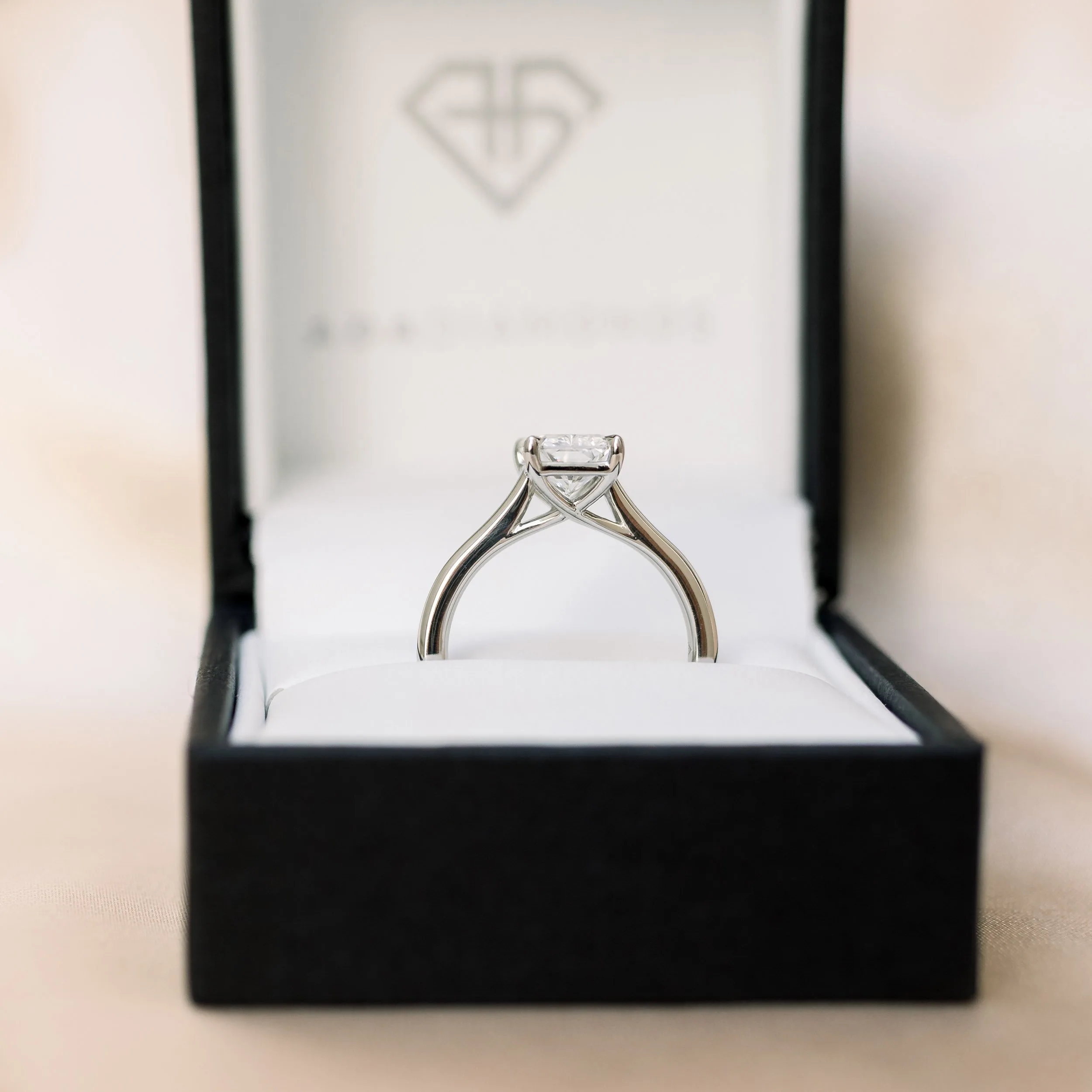 platinum two carat radiant cut man made diamond trellis solitaire engagement ring profile view