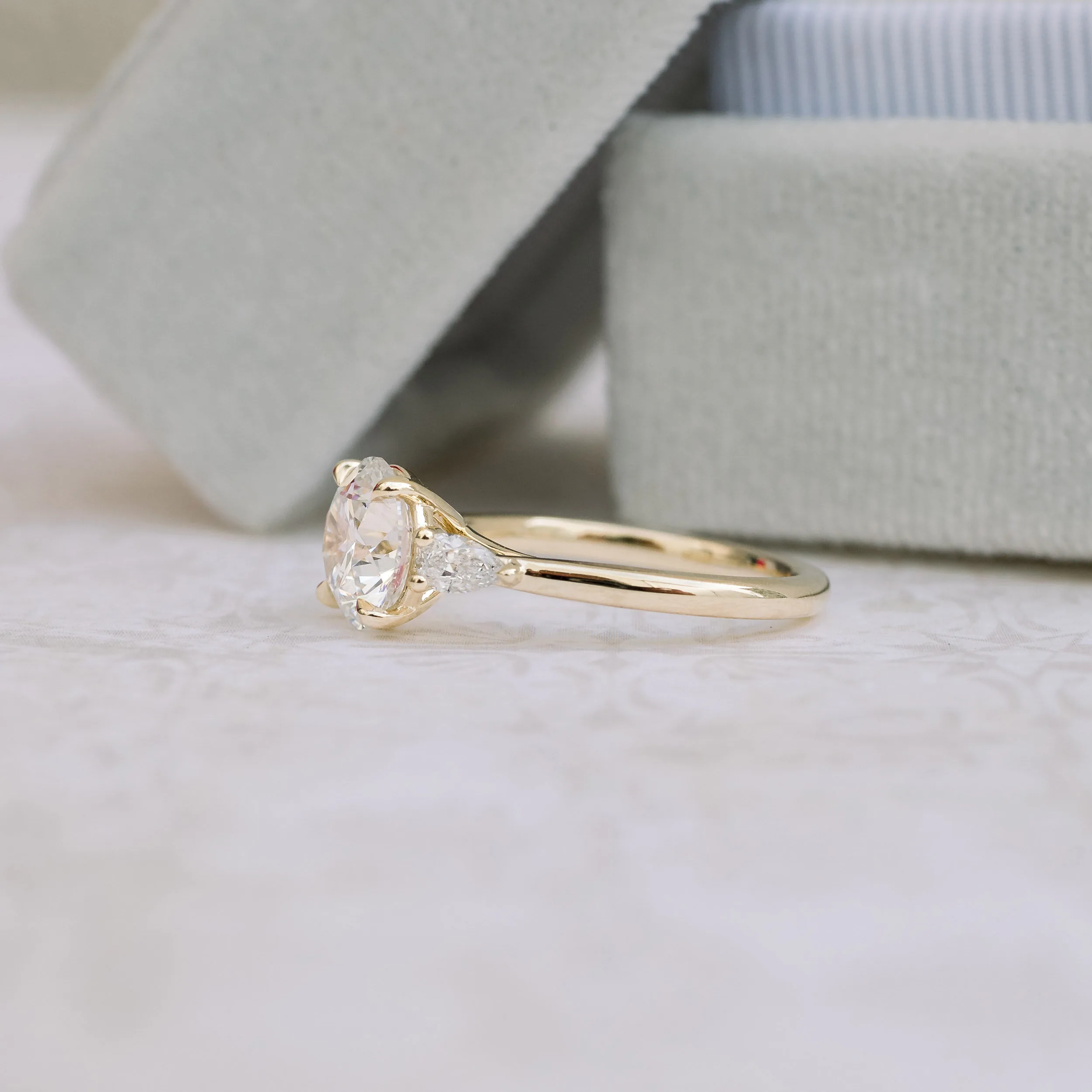 Yellow Gold Round and Pear Manmade Diamond Engagement Ring Profile View