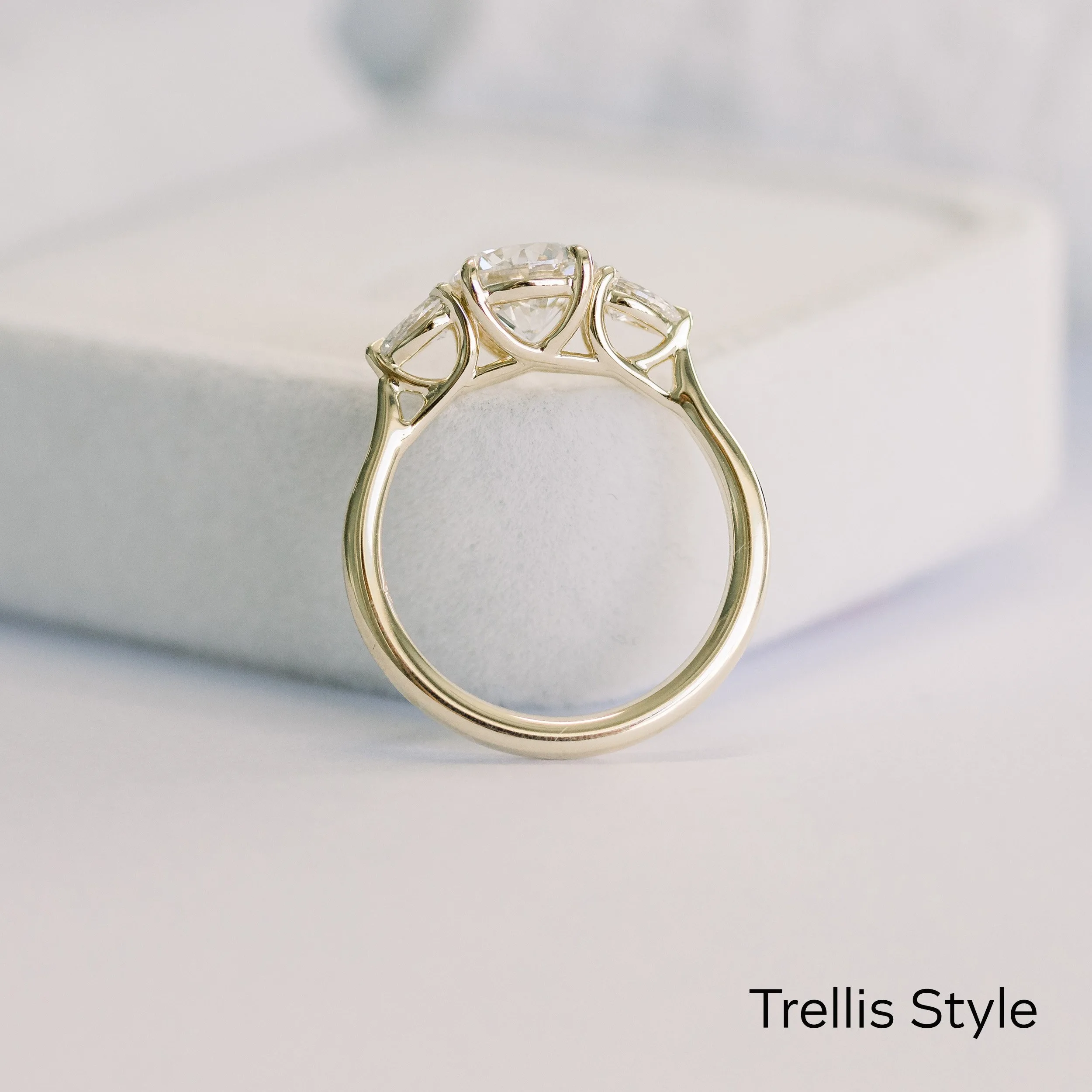 14k yellow gold trellis three stone ring with round and pears lab grown diamonds
