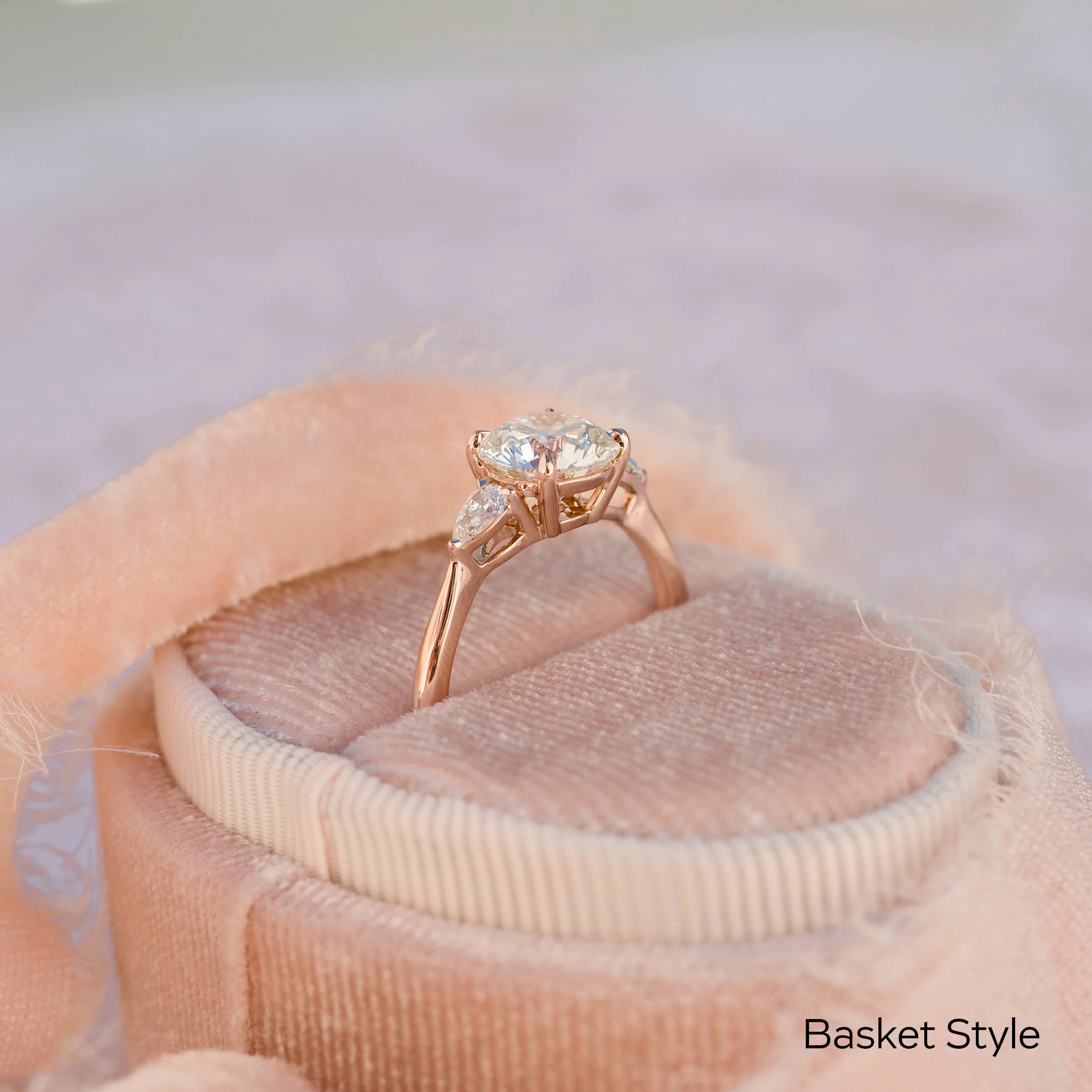 basket style round and pear three stone lab diamond engagement ring in 18k rose gold