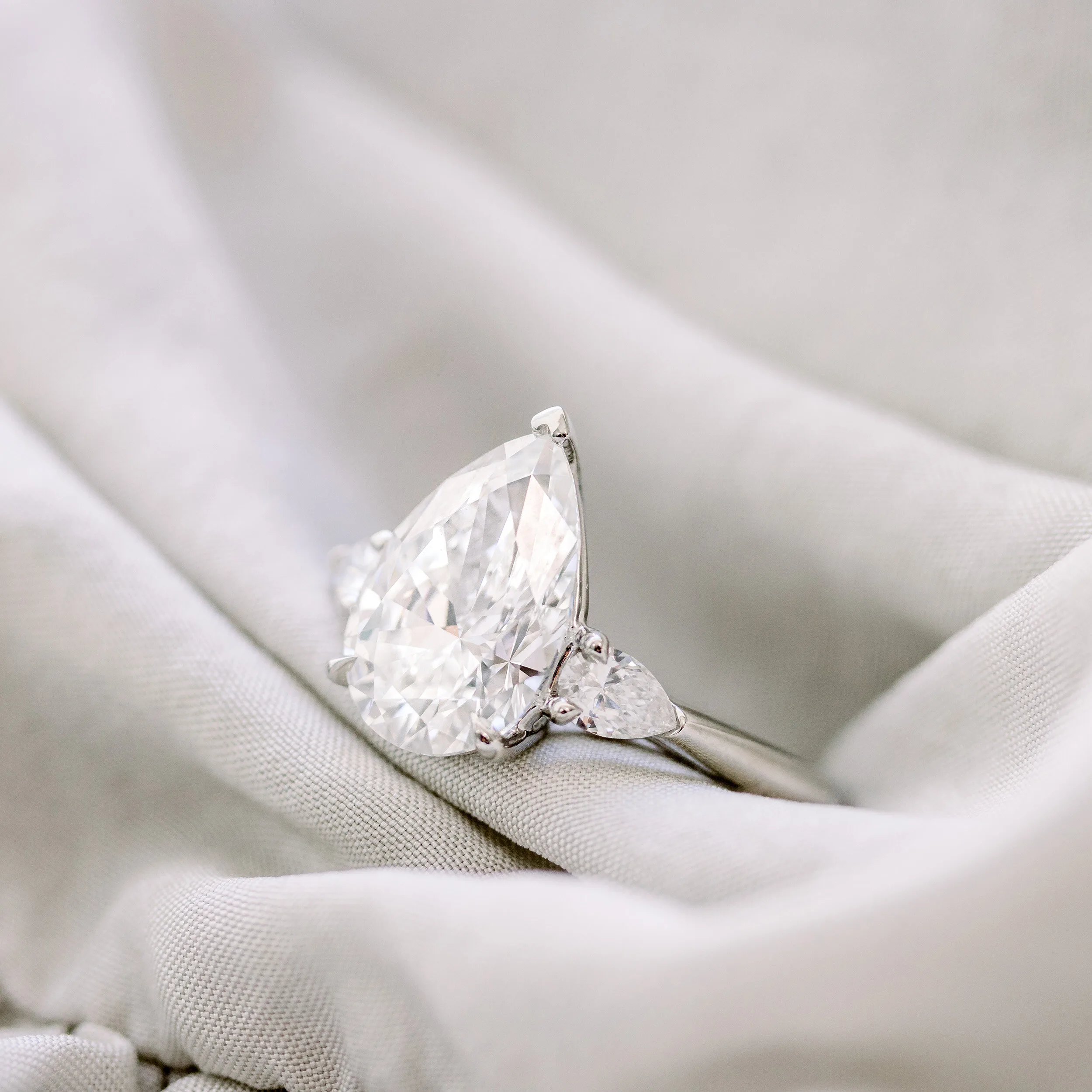 platinum pear three stone engagement ring featuring lab created diamonds
