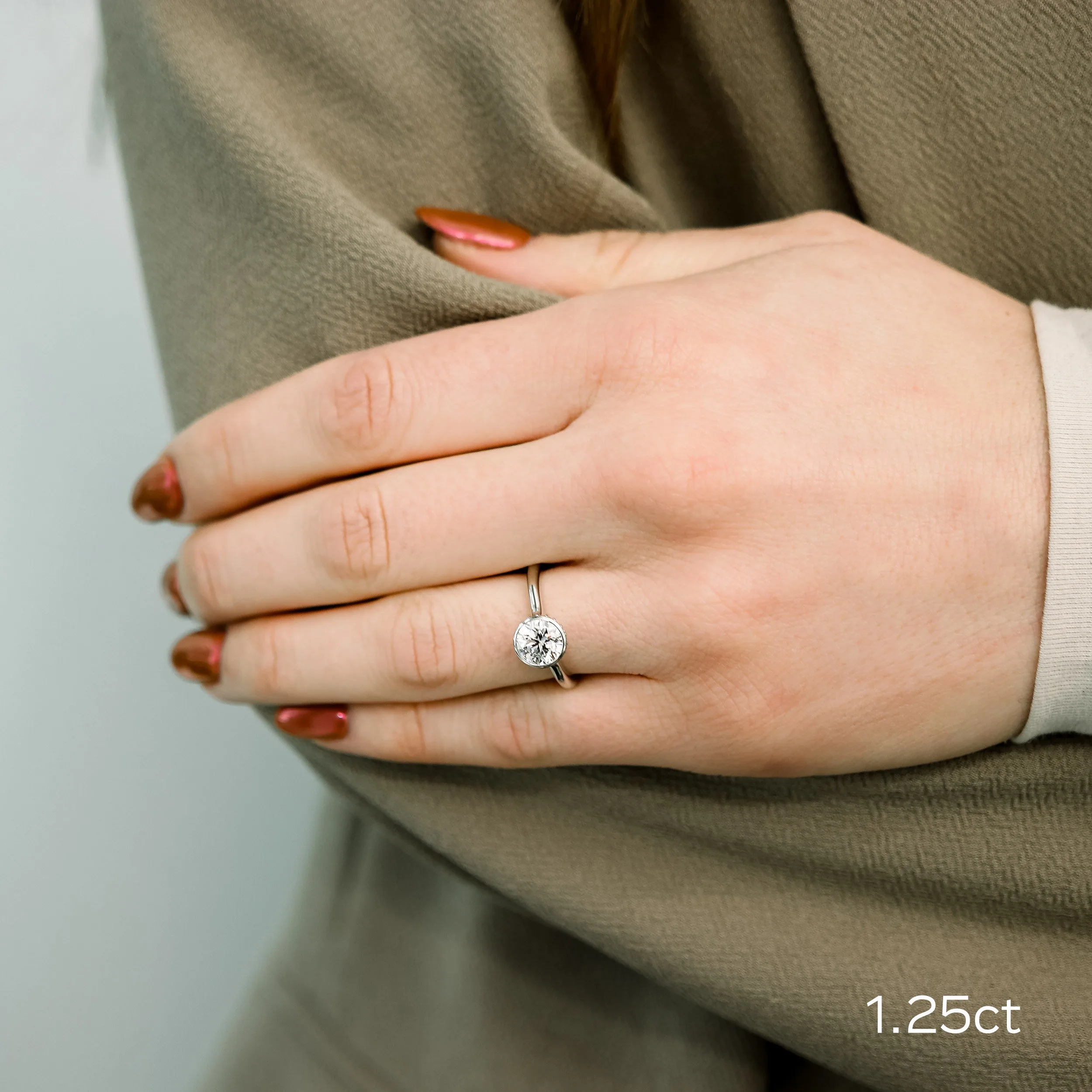 platinum 1.25 ct round lab diamond bezel solitaire engagement ring ada diamonds design ad148 on model