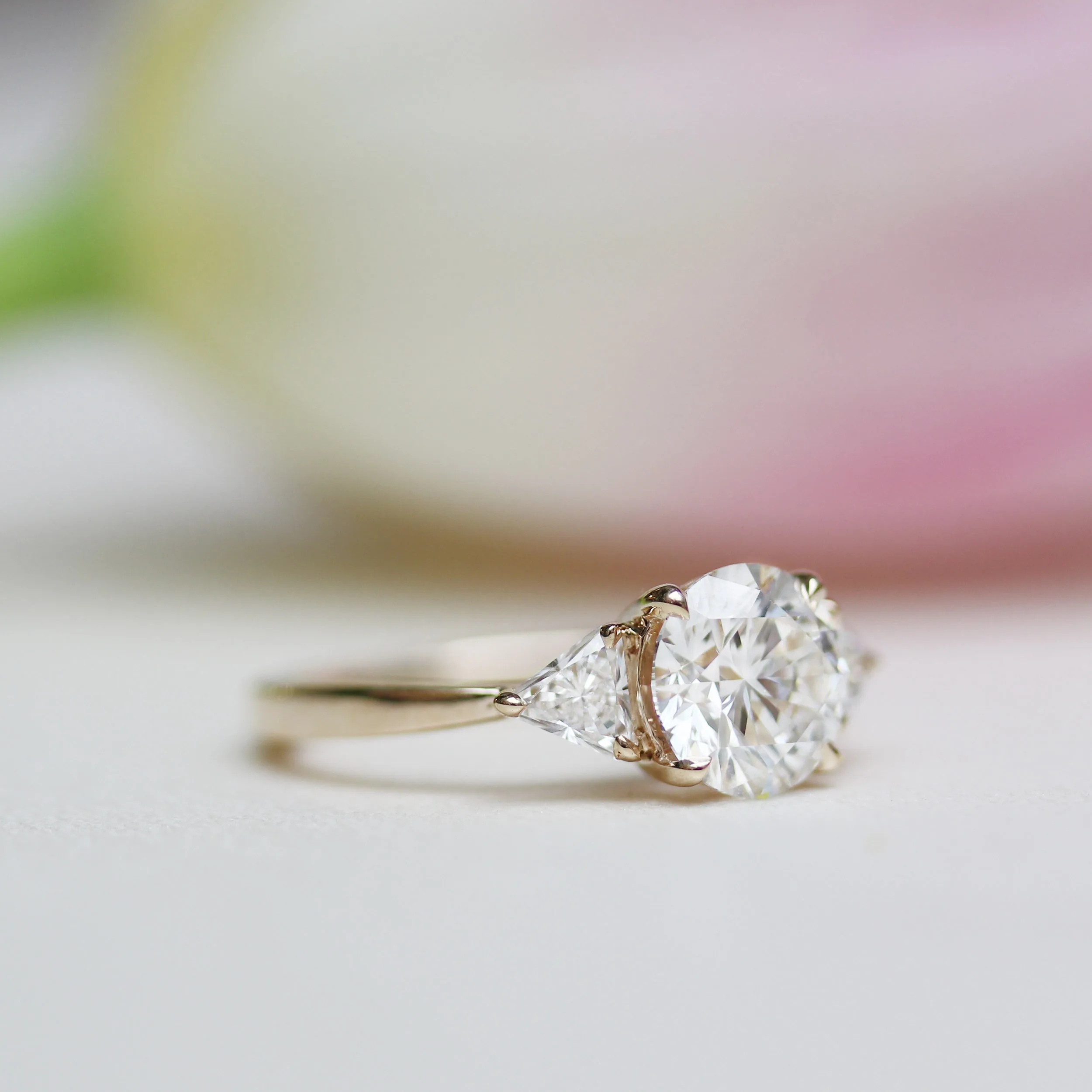 round and trillion three stone lab diamond engagement ring in yellow gold