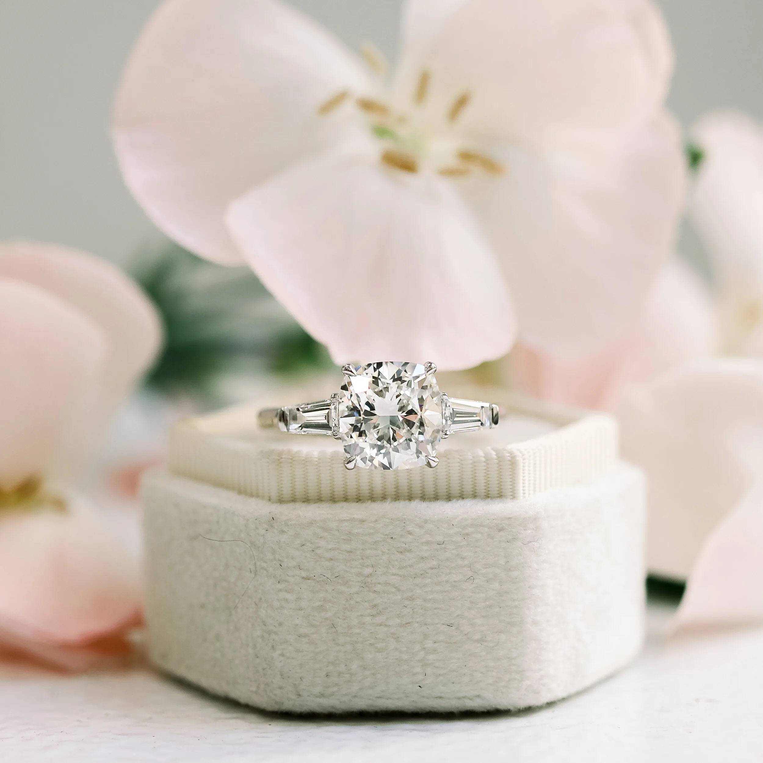 custom three stone engagement ring with lab grown cushion cut diamonds and baguette side stones