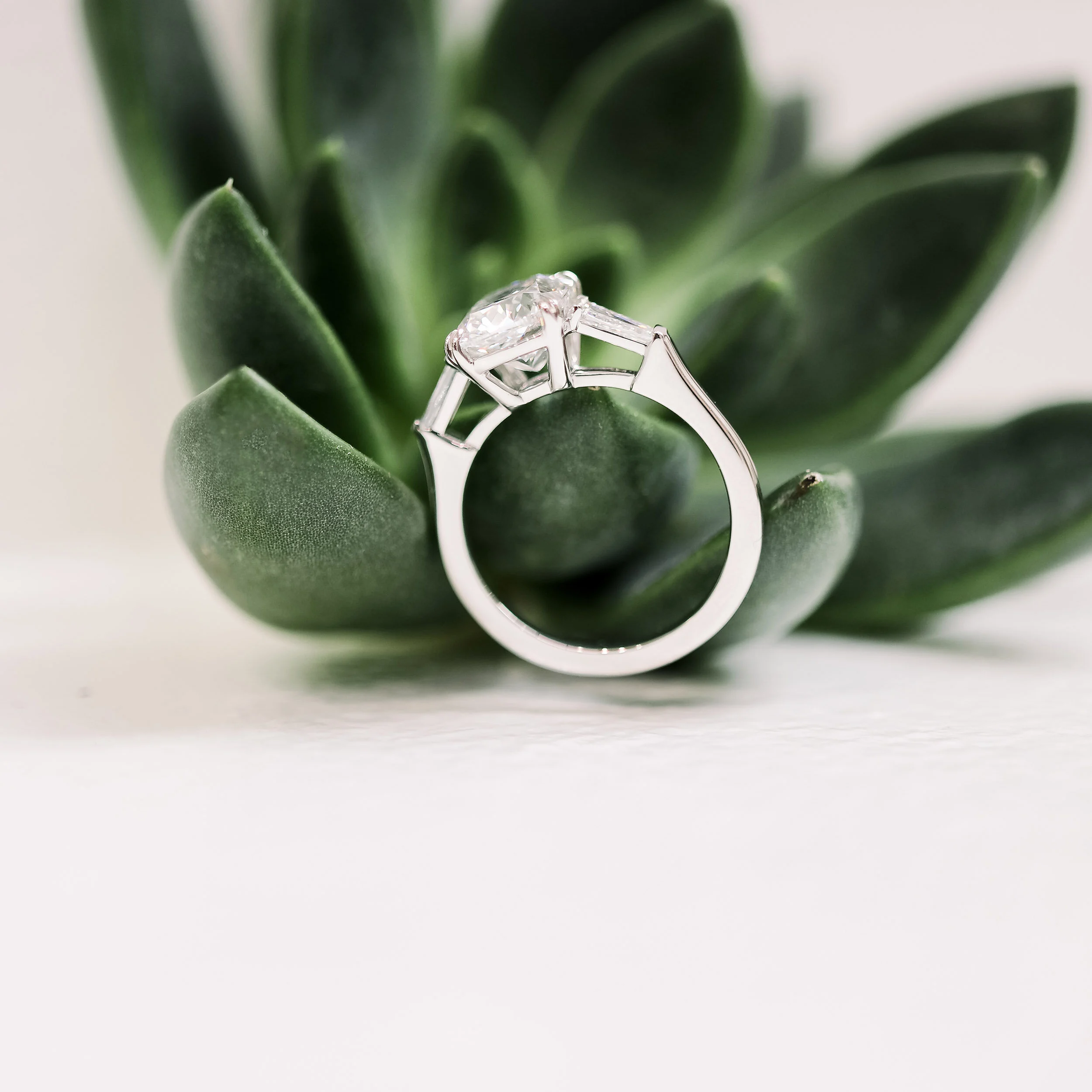 lab created cushion and tapered baguette three stone engagement ring