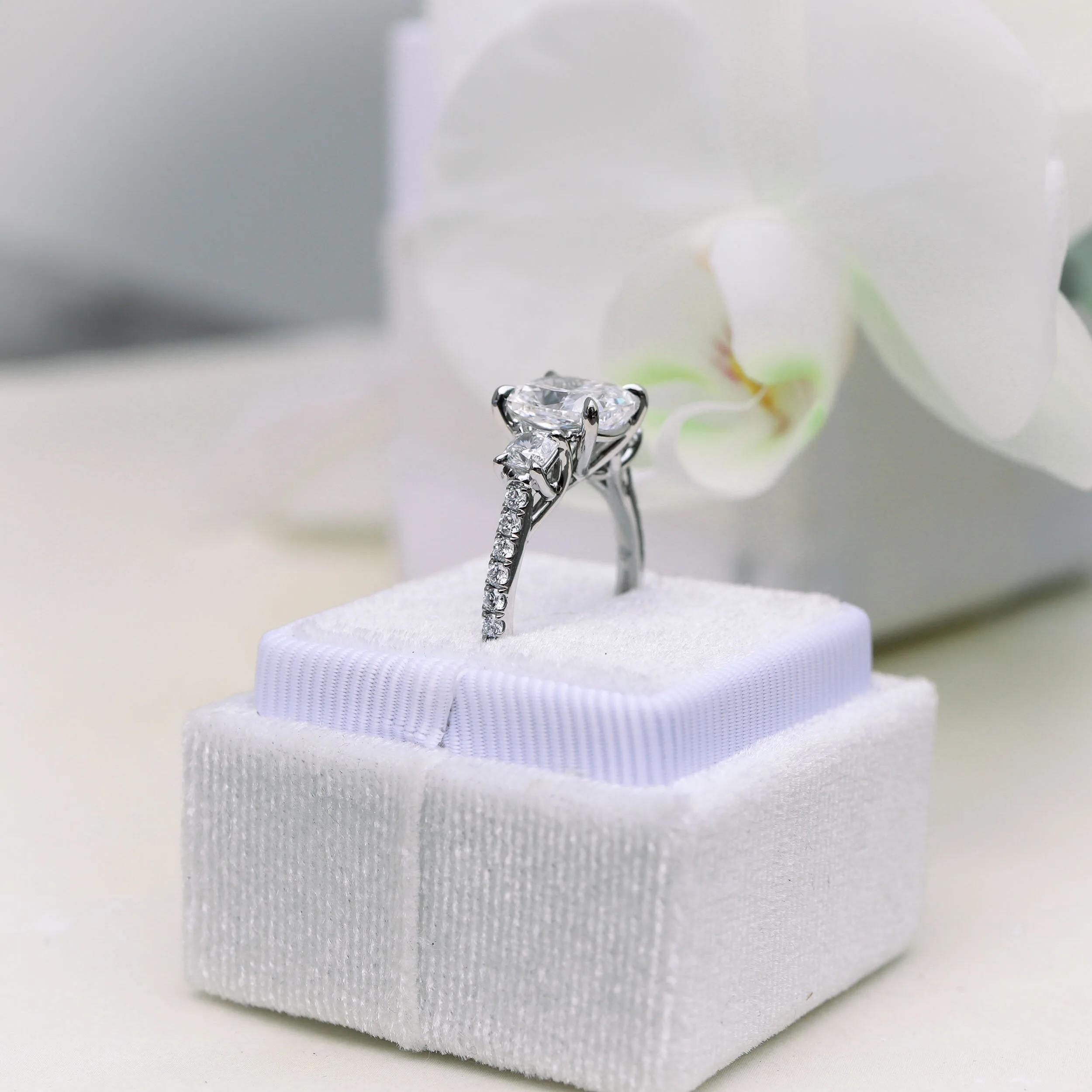 platinum three stone pave ring with 2.5ct lab grown cushion cut diamond
