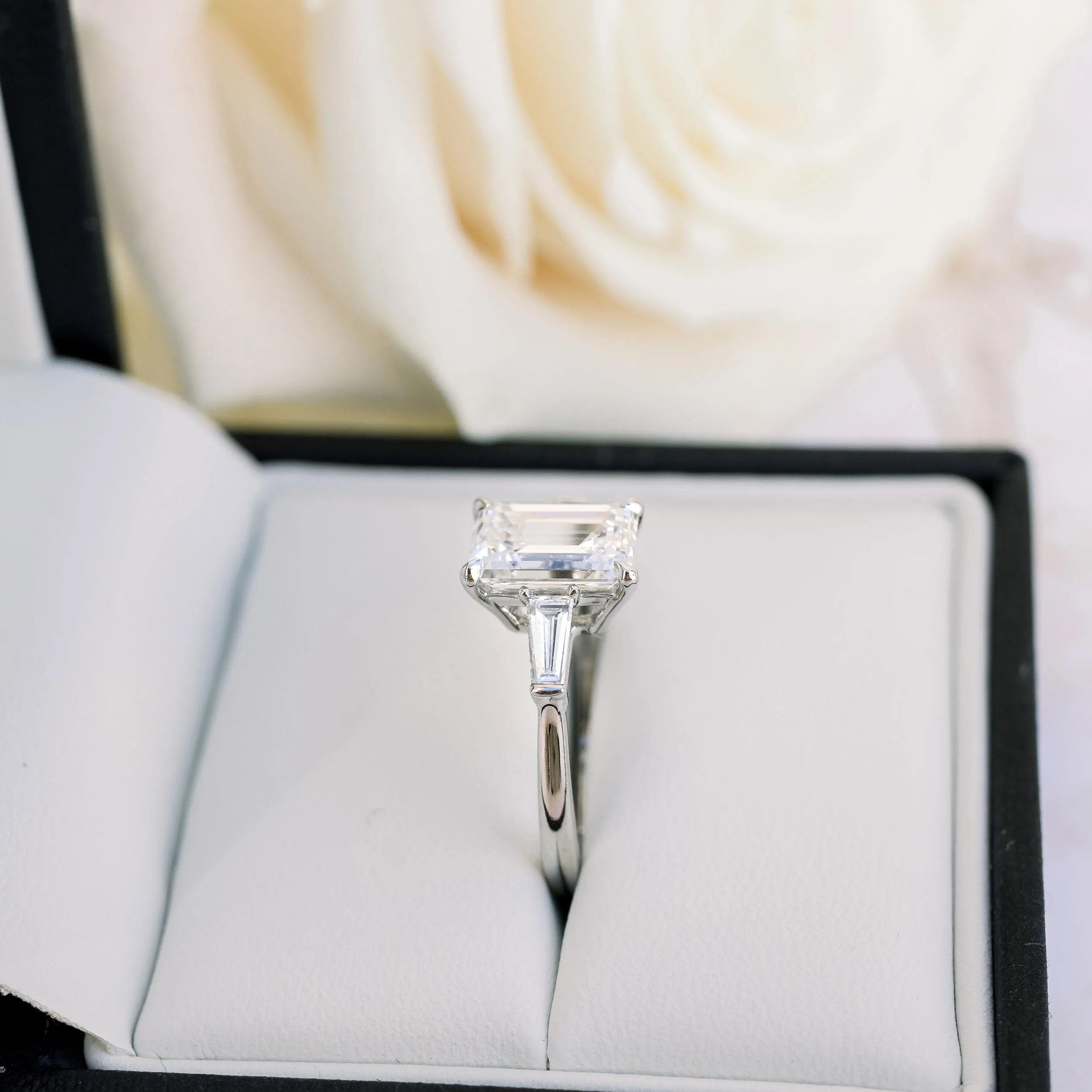 white gold ring with emerald cut lab diamonds and baguette side stones