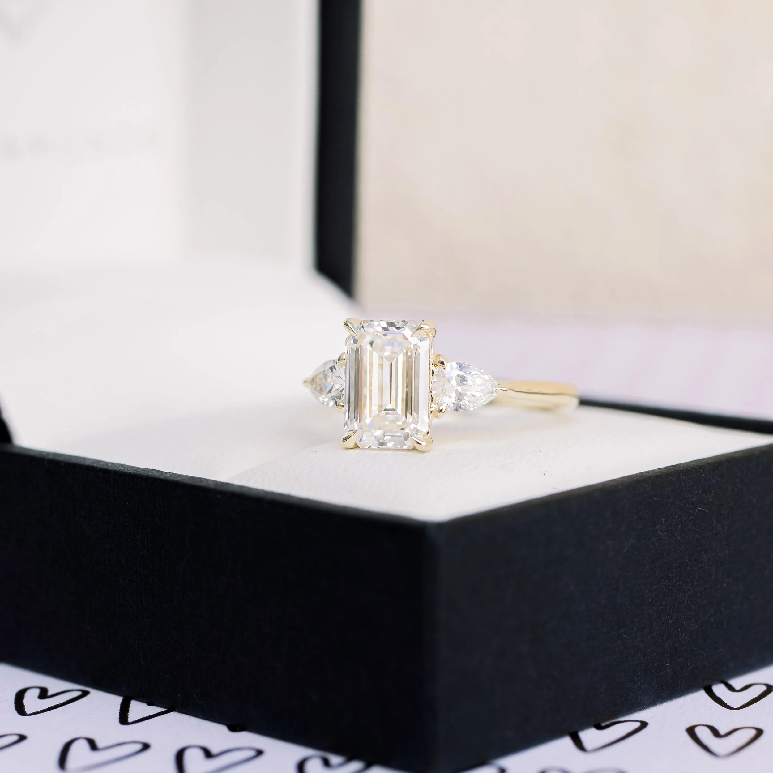 Yellow Gold Two Carat Emerald Cut Lab Diamond Engagement Ring with Pear Side Stones Ada Diamonds Design AD-467 in Black Box