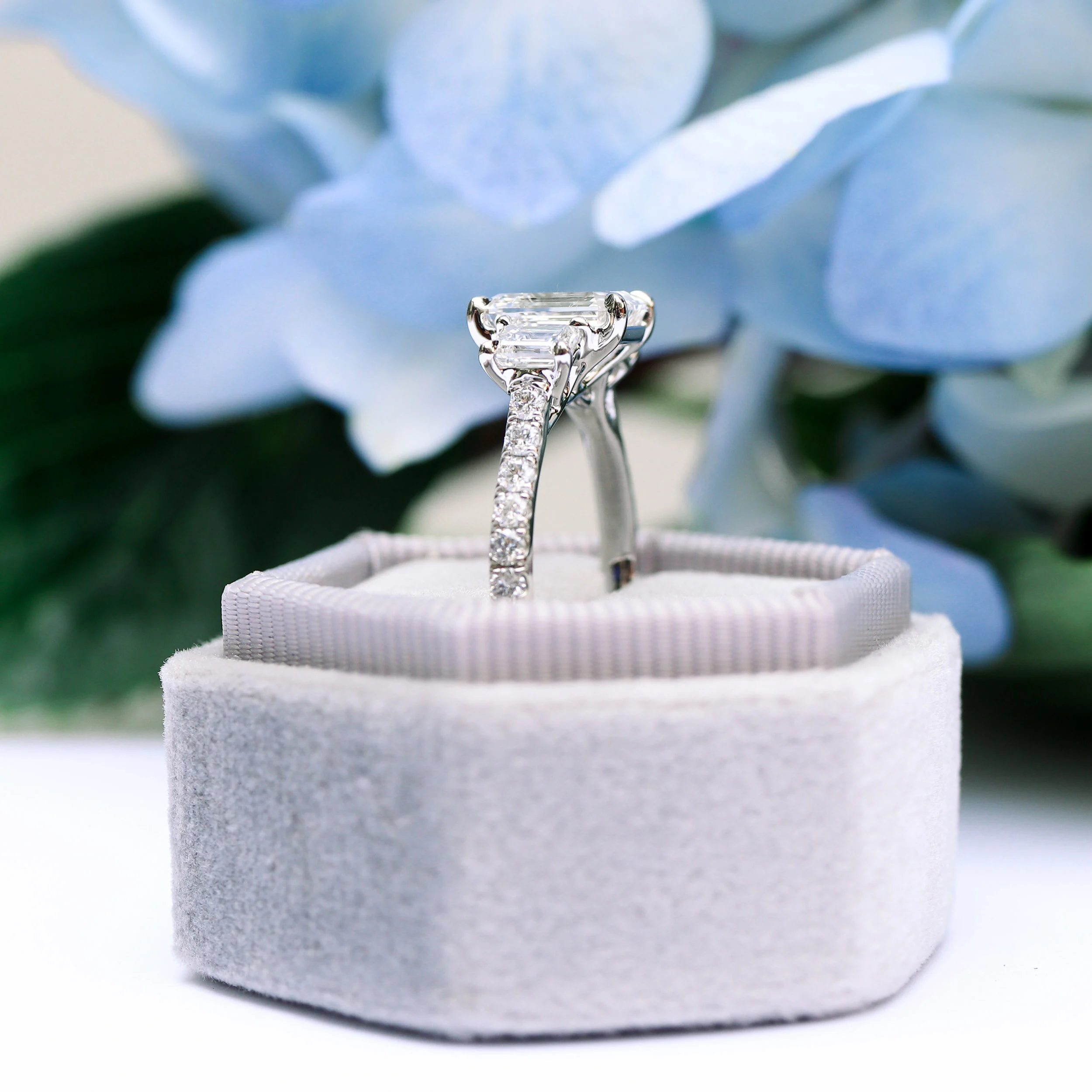 platinum emerald three stone pave engagement ring