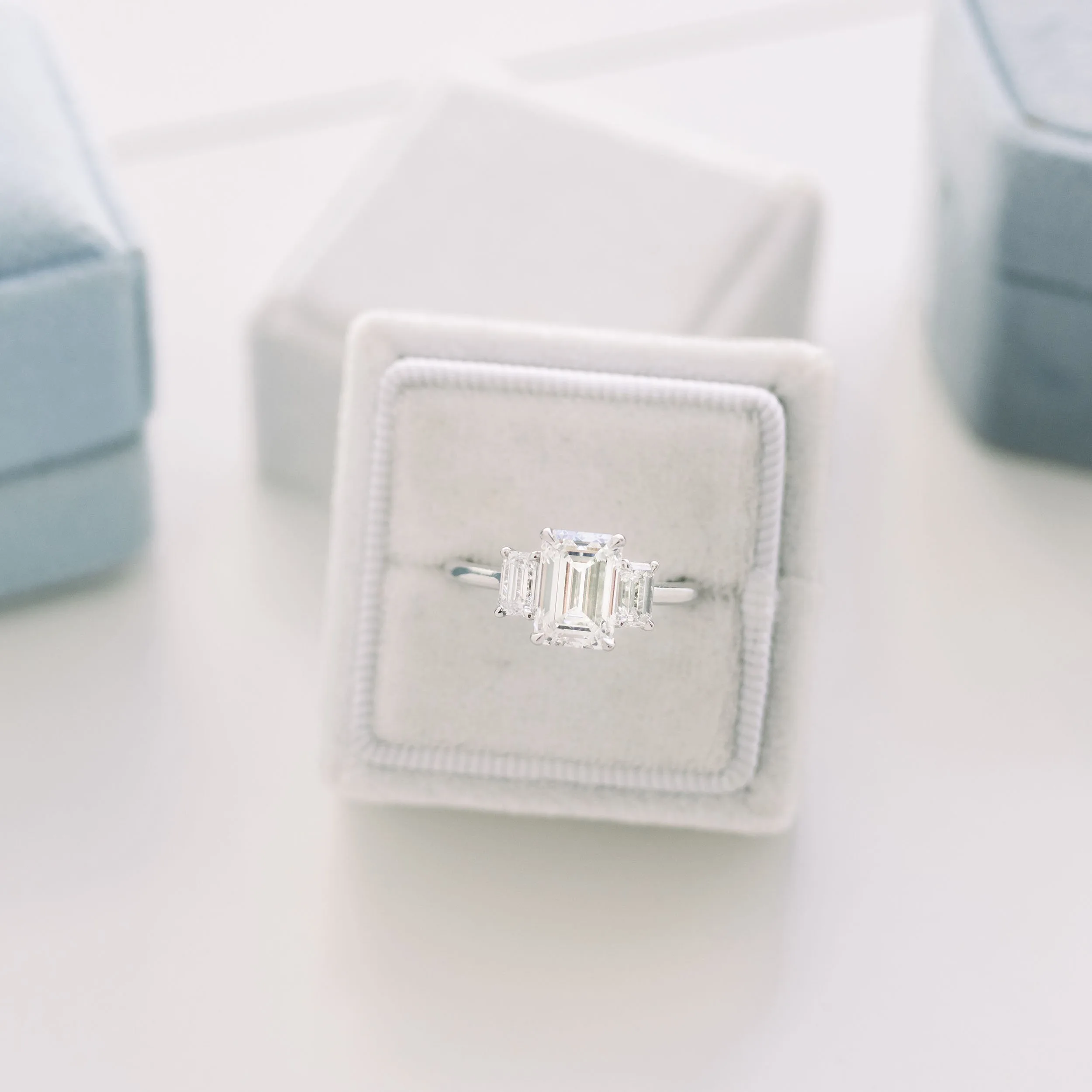 Platinum 2.25 carat emerald three stone lab diamond engagement ring with emerald side stones ada diamonds design ad-114