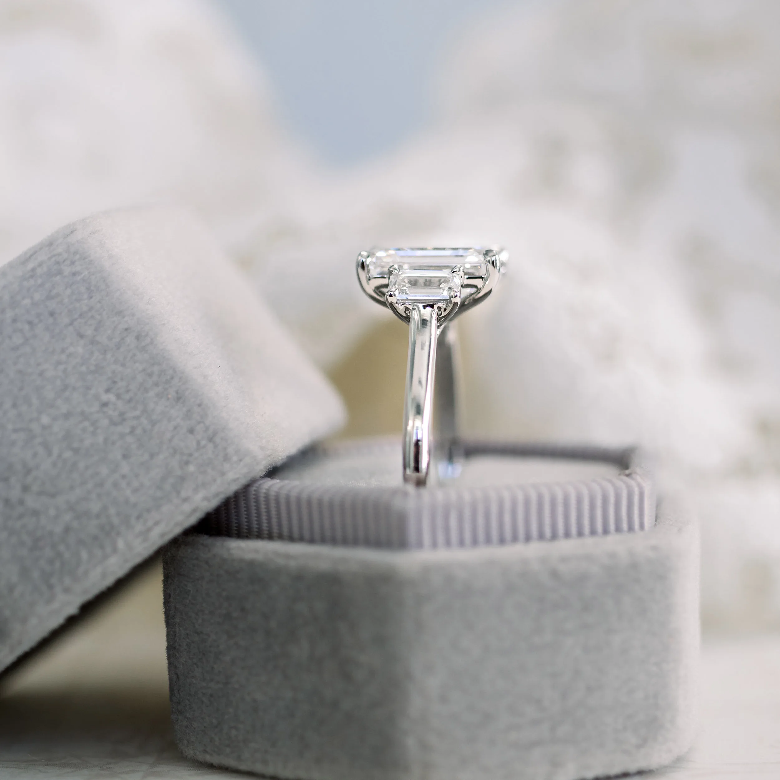 three stone engagement ring with emerald cut lab diamonds