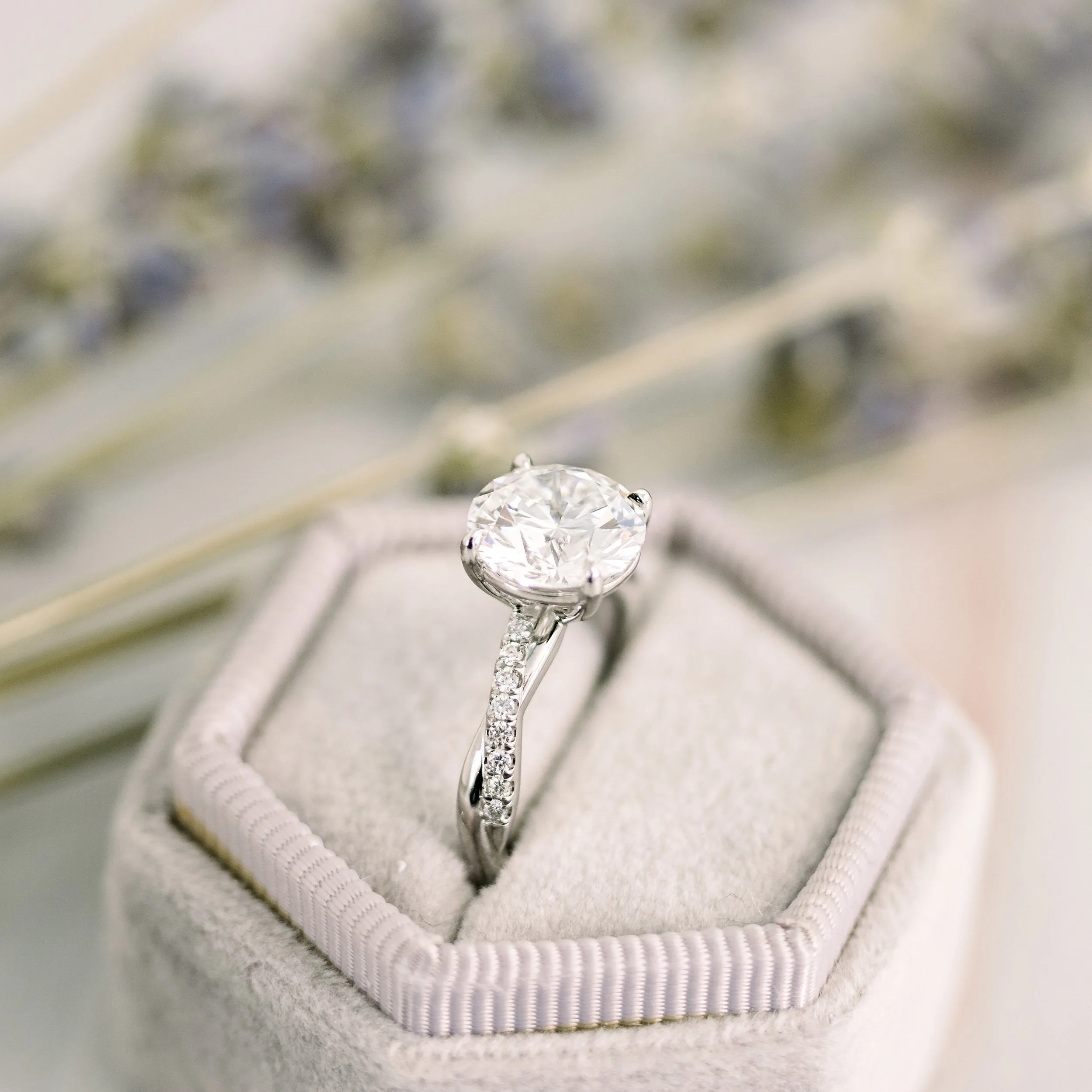 platinum two carat round laboratory grown diamond engagement ring with twisting diamond band ada diamonds design ad 154