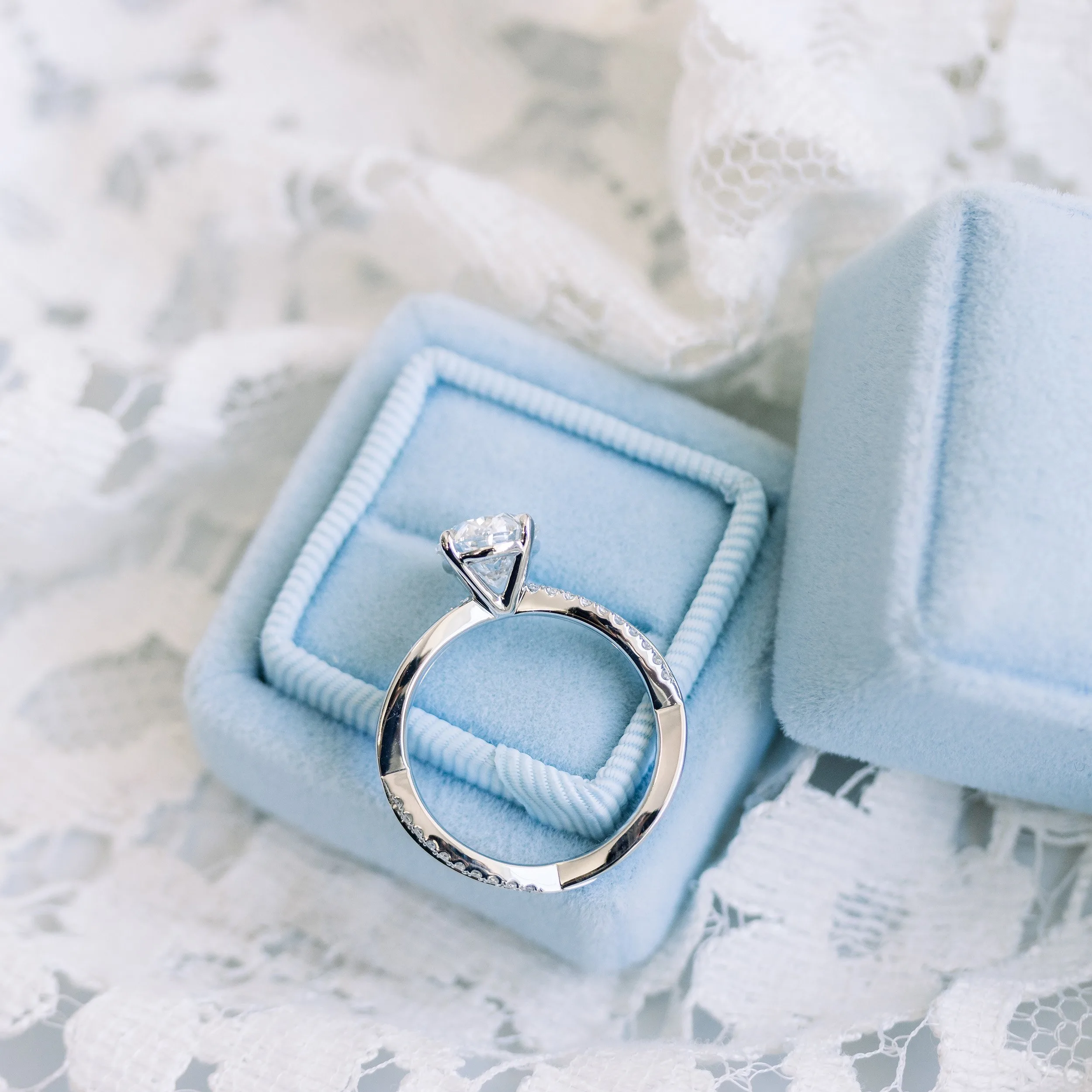 profile view of platinum 2.5ct oval lab diamond engagement ring with infinity twist diamond band ada diamonds design ad 154