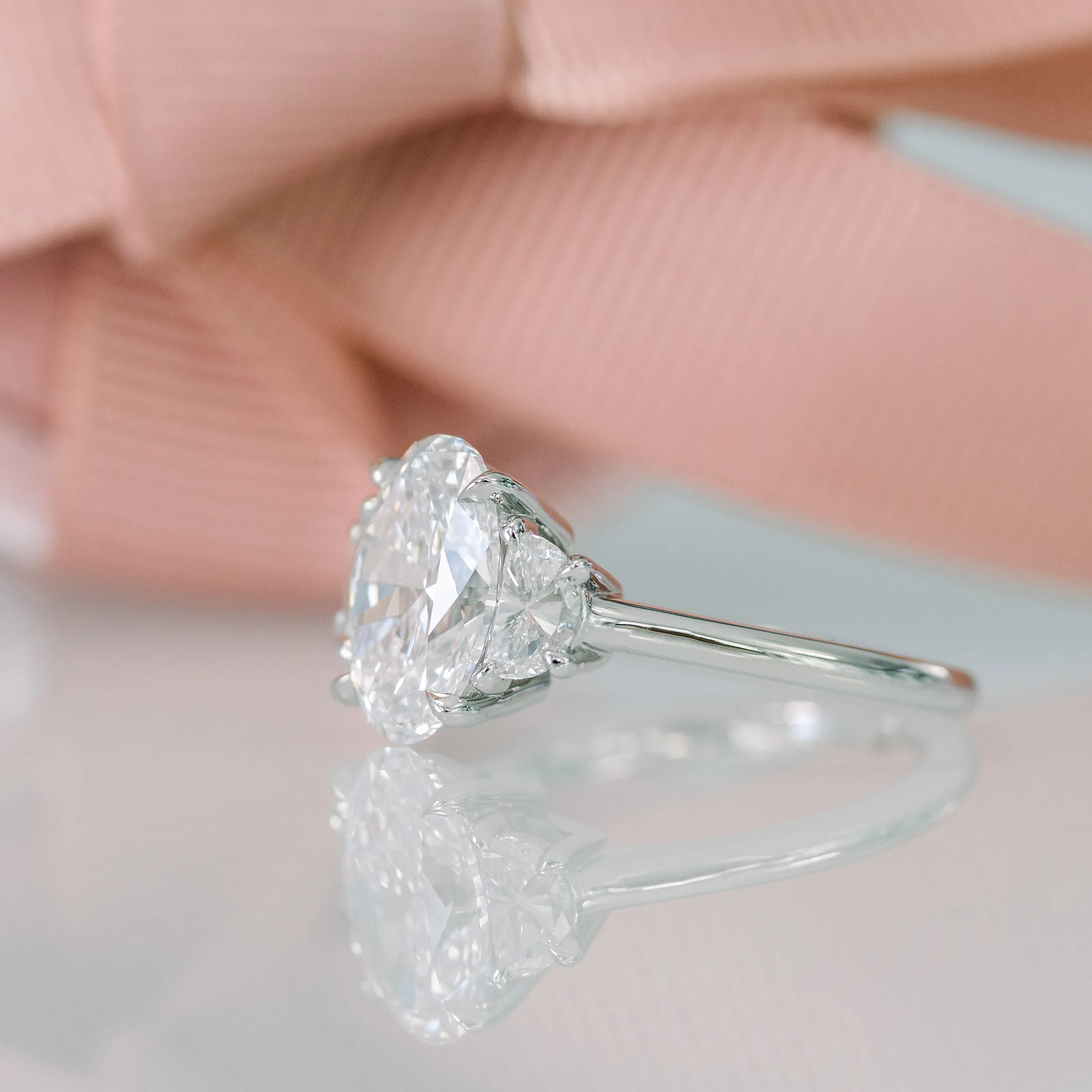 lab created three stone engagement ring with oval and half moons