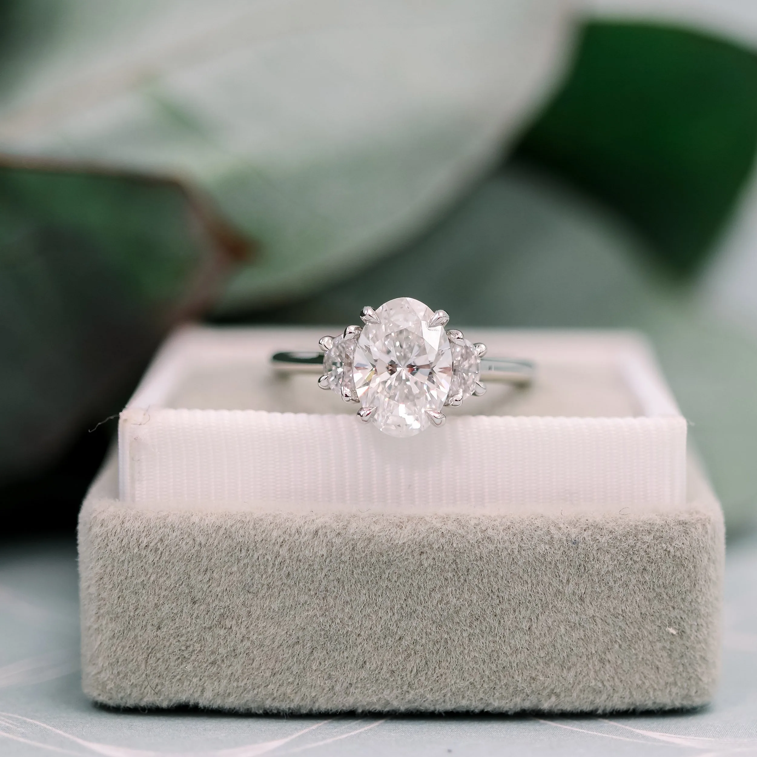lab created oval three stone engagement ring