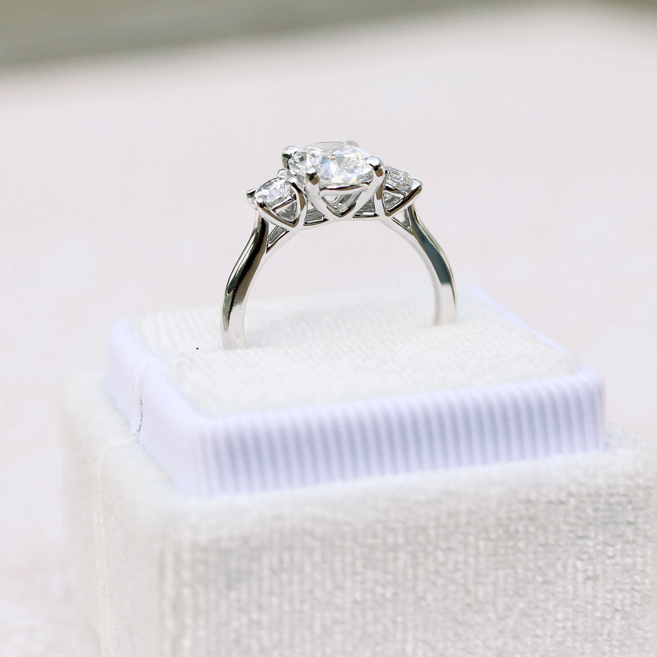 oval and round setting in platinum featuring a trellis basket set with oval and round laboratory grown diamonds