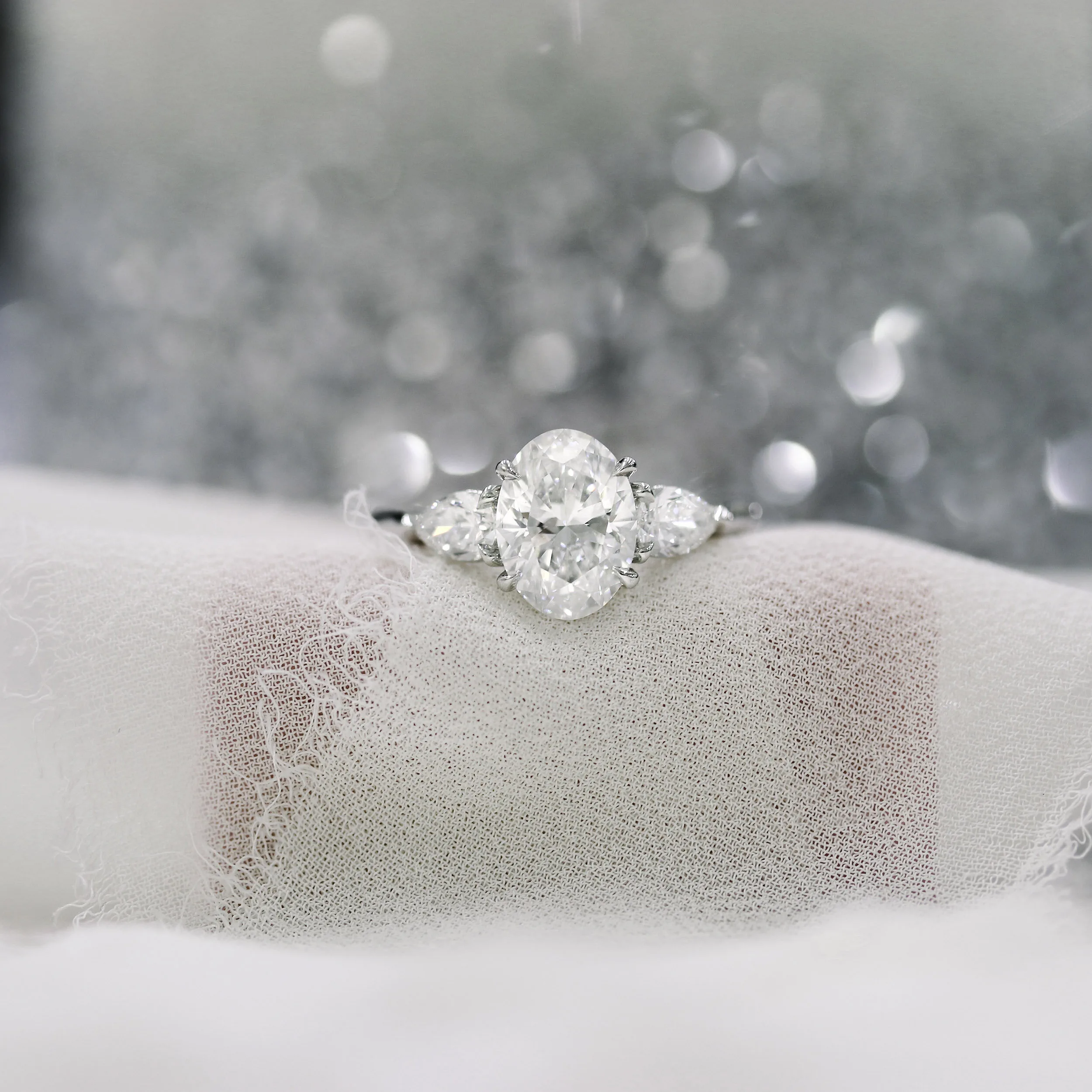platinum oval and pear engagement ring featuring lab created diamonds