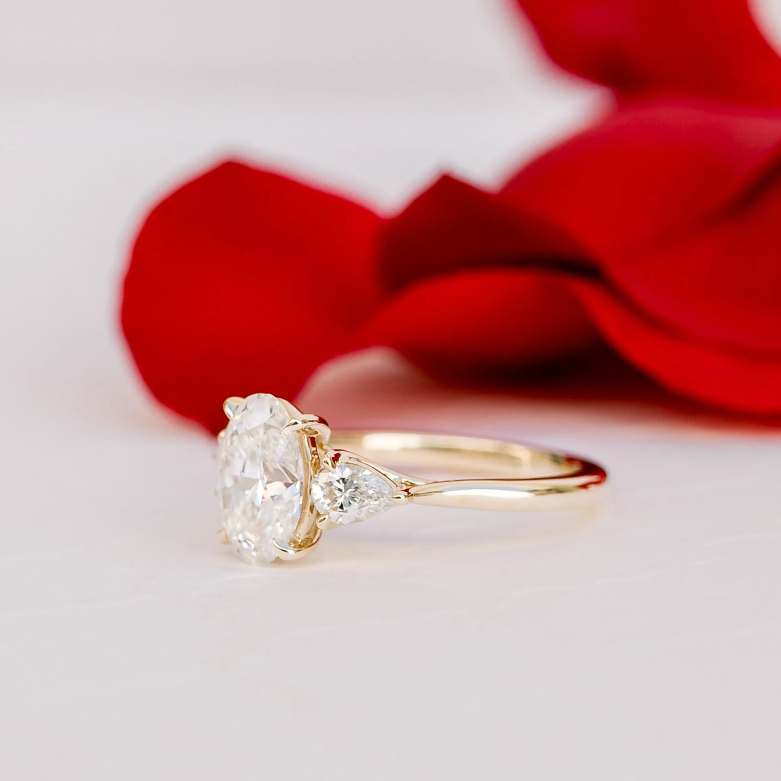 14k gold setting featuring lab grown oval diamond with pear cut lab grown diamond side stones ada diamonds design ad-460