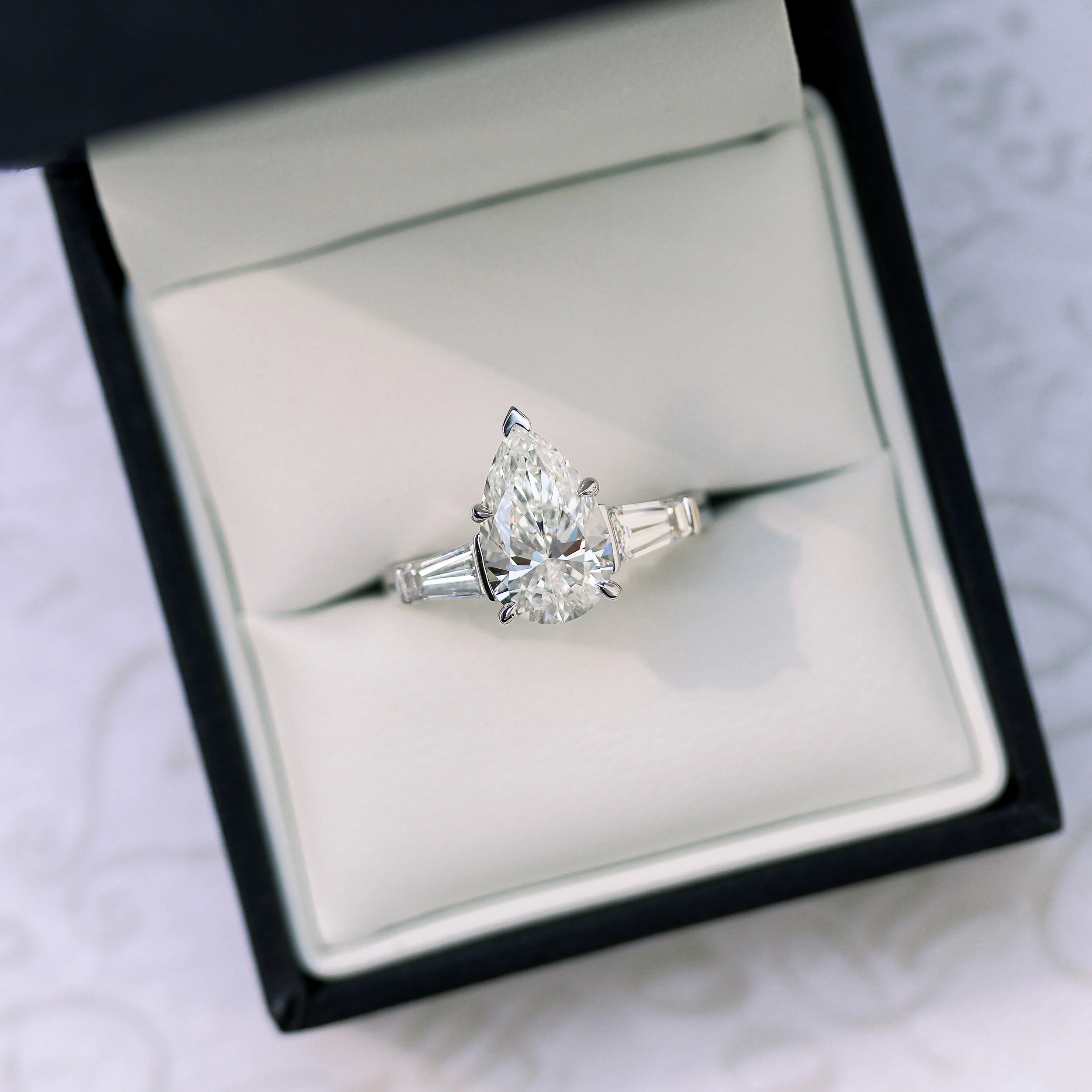 platinum three stone ring with lab grown pear and baguette diamonds