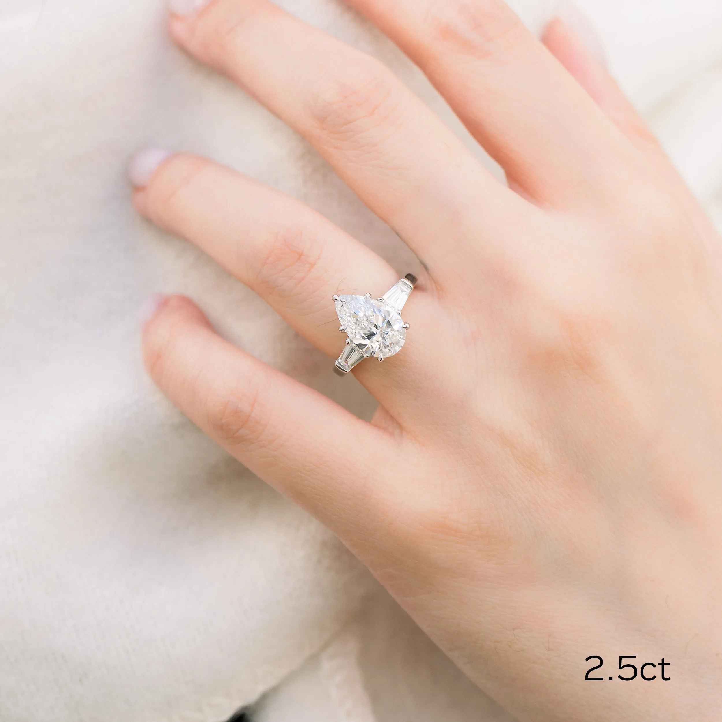 platinum 2.5 carat pear and baguette three stone lab created diamond engagement ring on model ada diamonds design ad 495