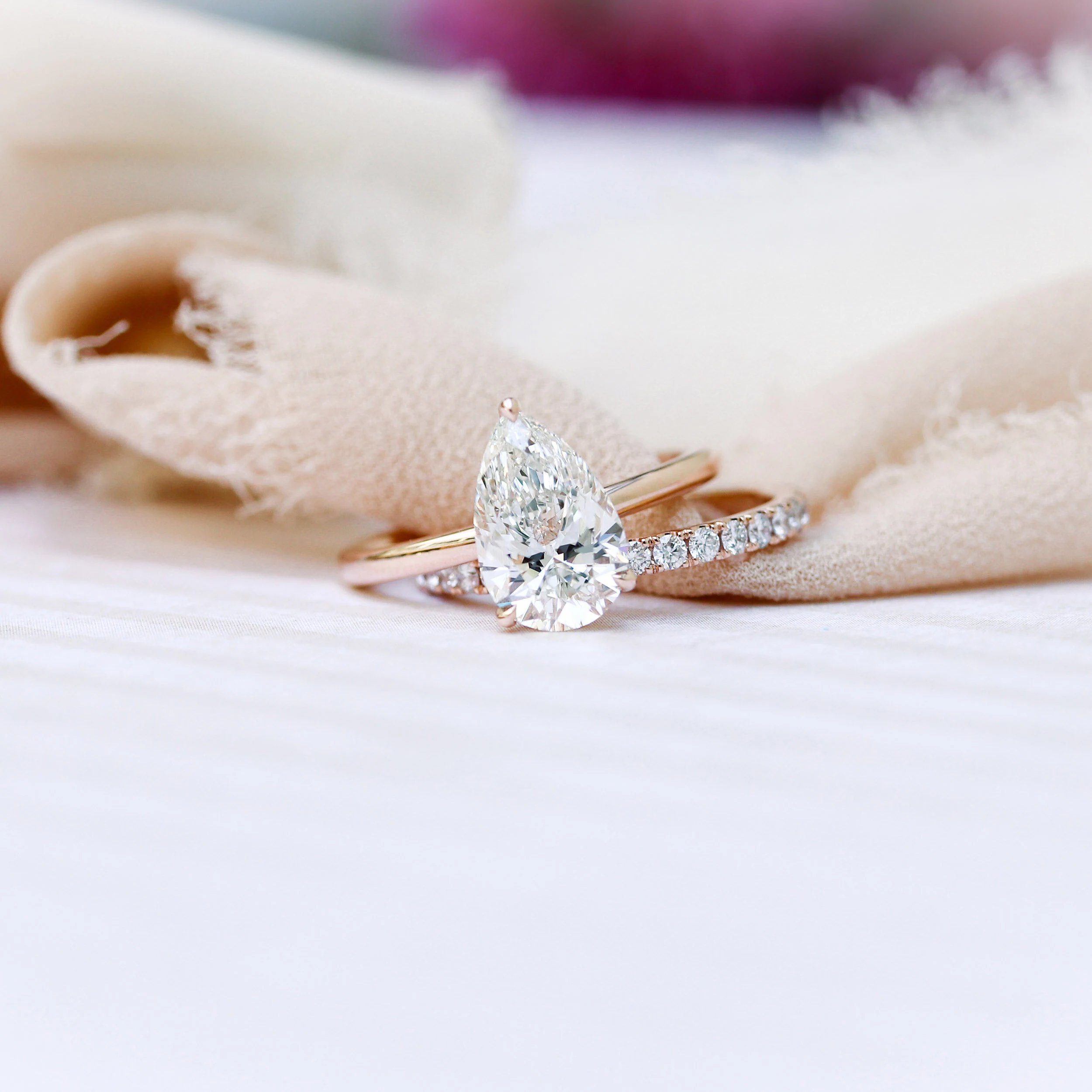 14k Rose Gold Two Carat Pear Solitaire Engagement Ring and U Pavé 3/4 Eternity Band featuring Lab Diamonds Ada Diamonds Design Number AD-187 Artistic Shot