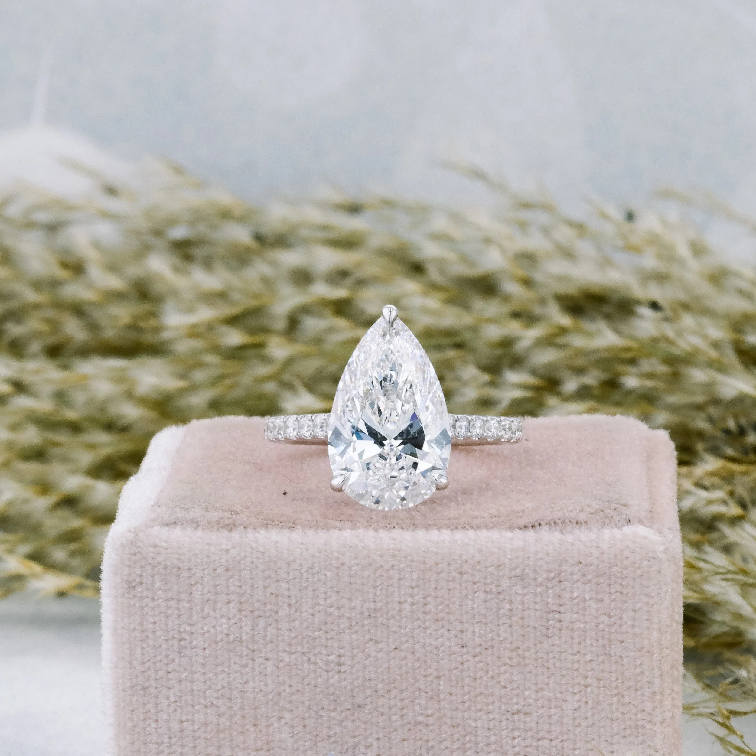 lab created pear diamond in cathedral pave setting