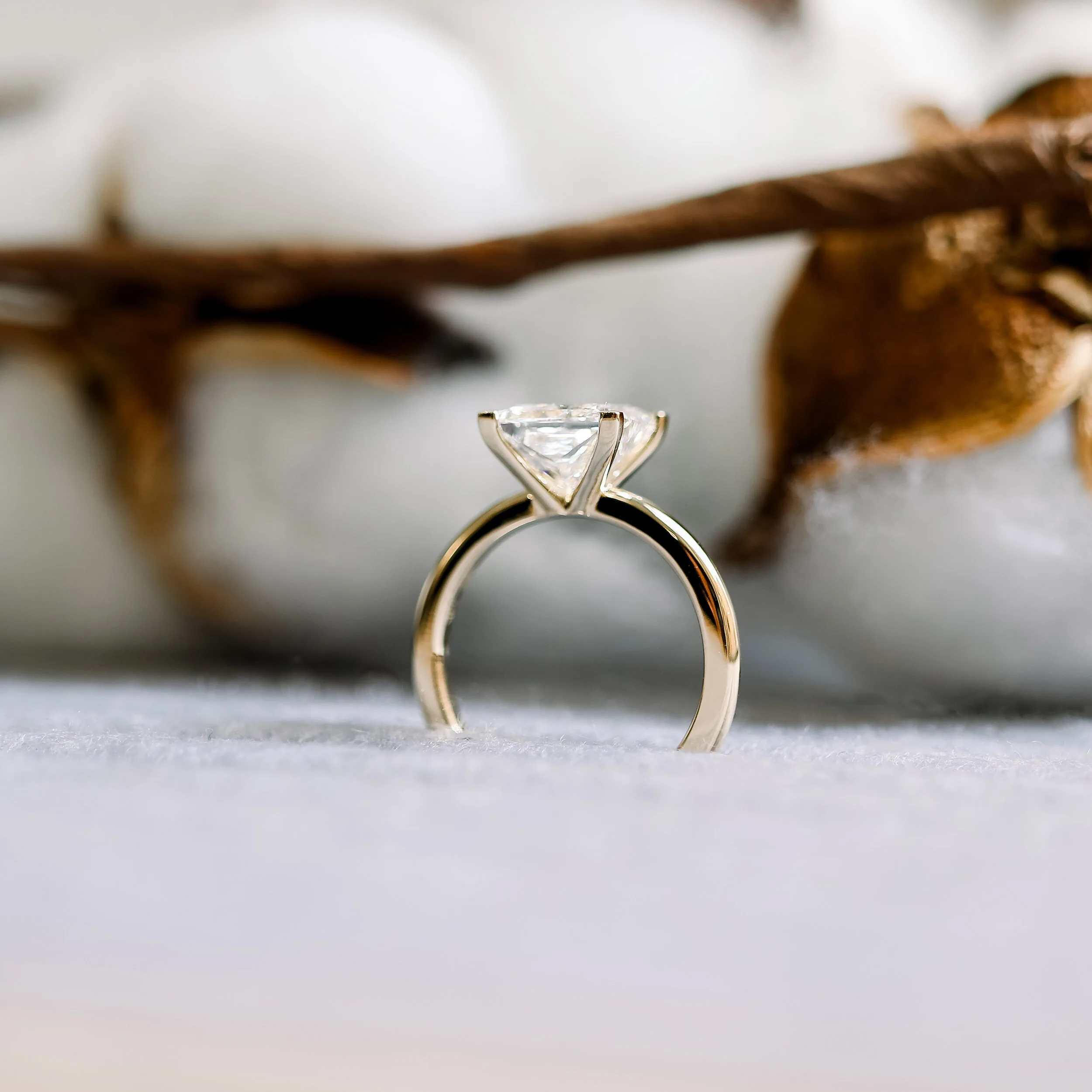 classic four prong solitaire in yellow gold