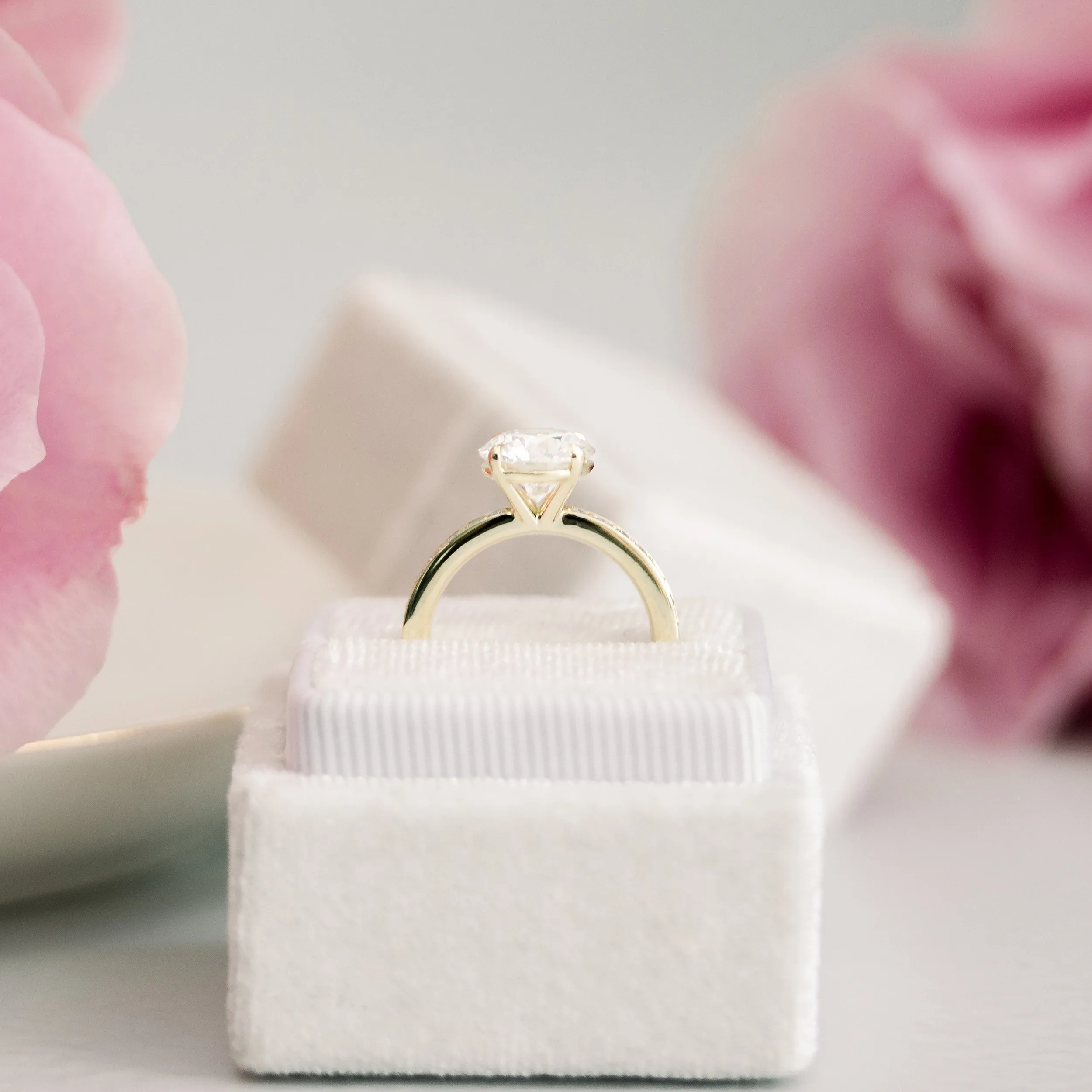 yellow gold 2 carat round manmade diamond engagement ring with channel set diamond band ada diamonds design ad 074