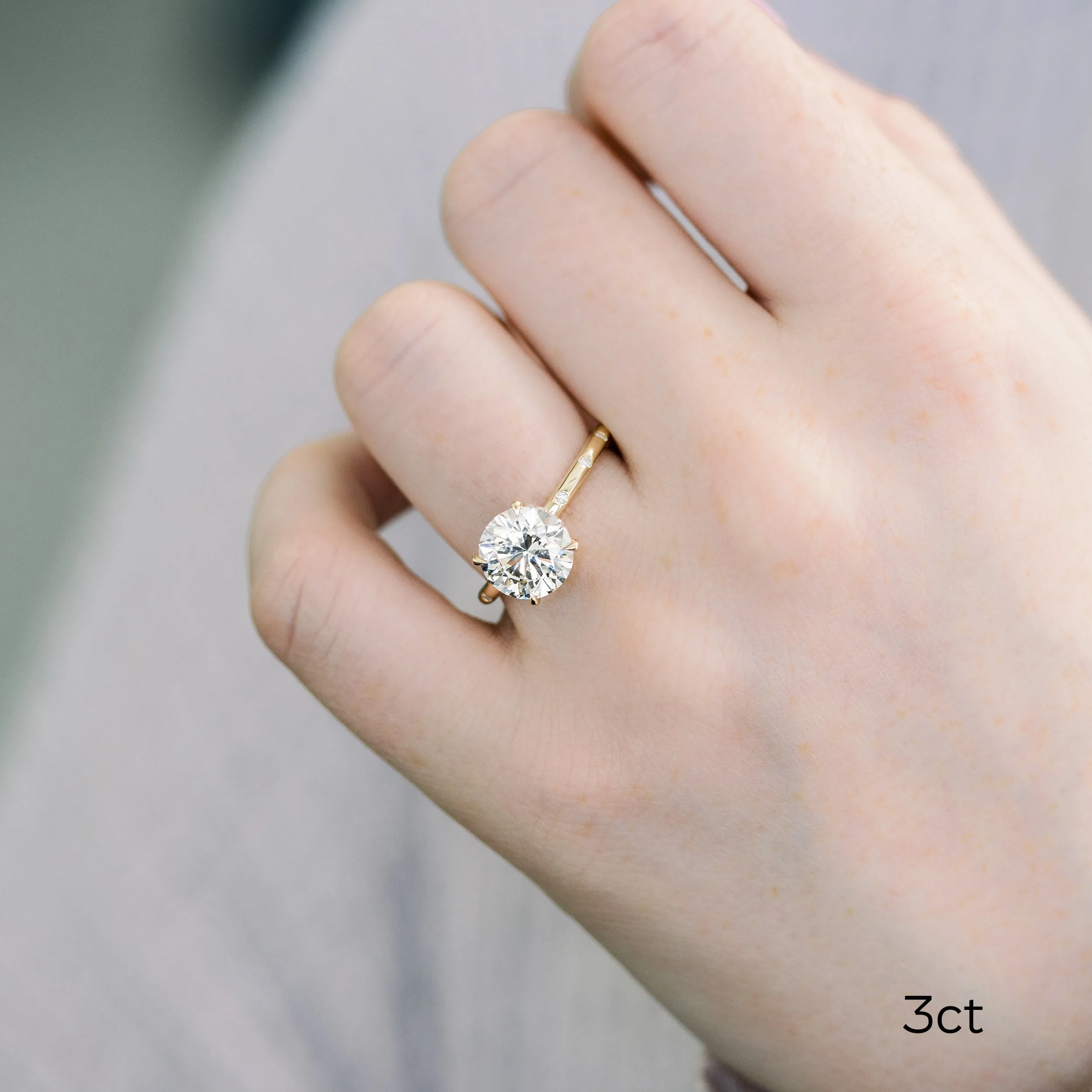 yellow gold custom 3 ct round lab diamond engagement ring with diamond accented band on model ada diamonds design ad178