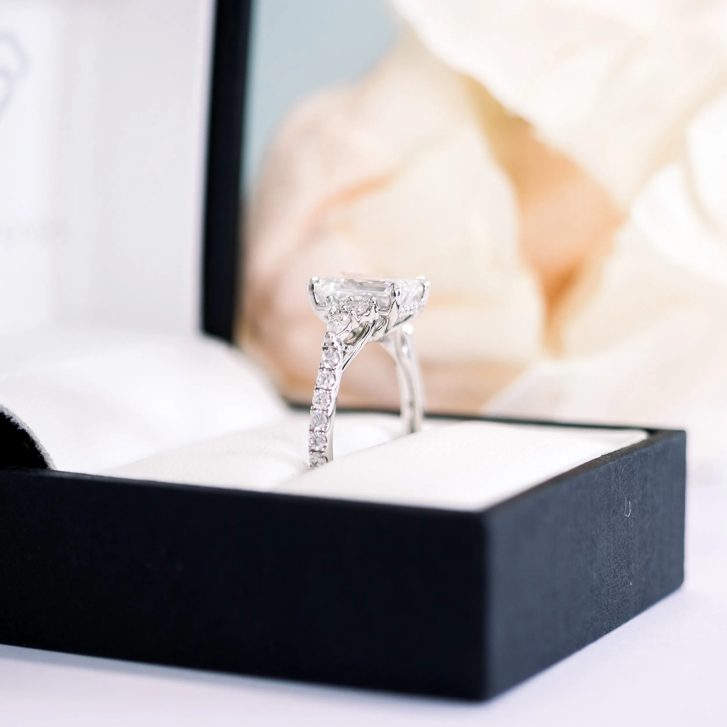 platinum 2.5 carat emerald cut lab diamond custom pavé engagement ring with cluster side stones ada diamonds design ad 178 profile view