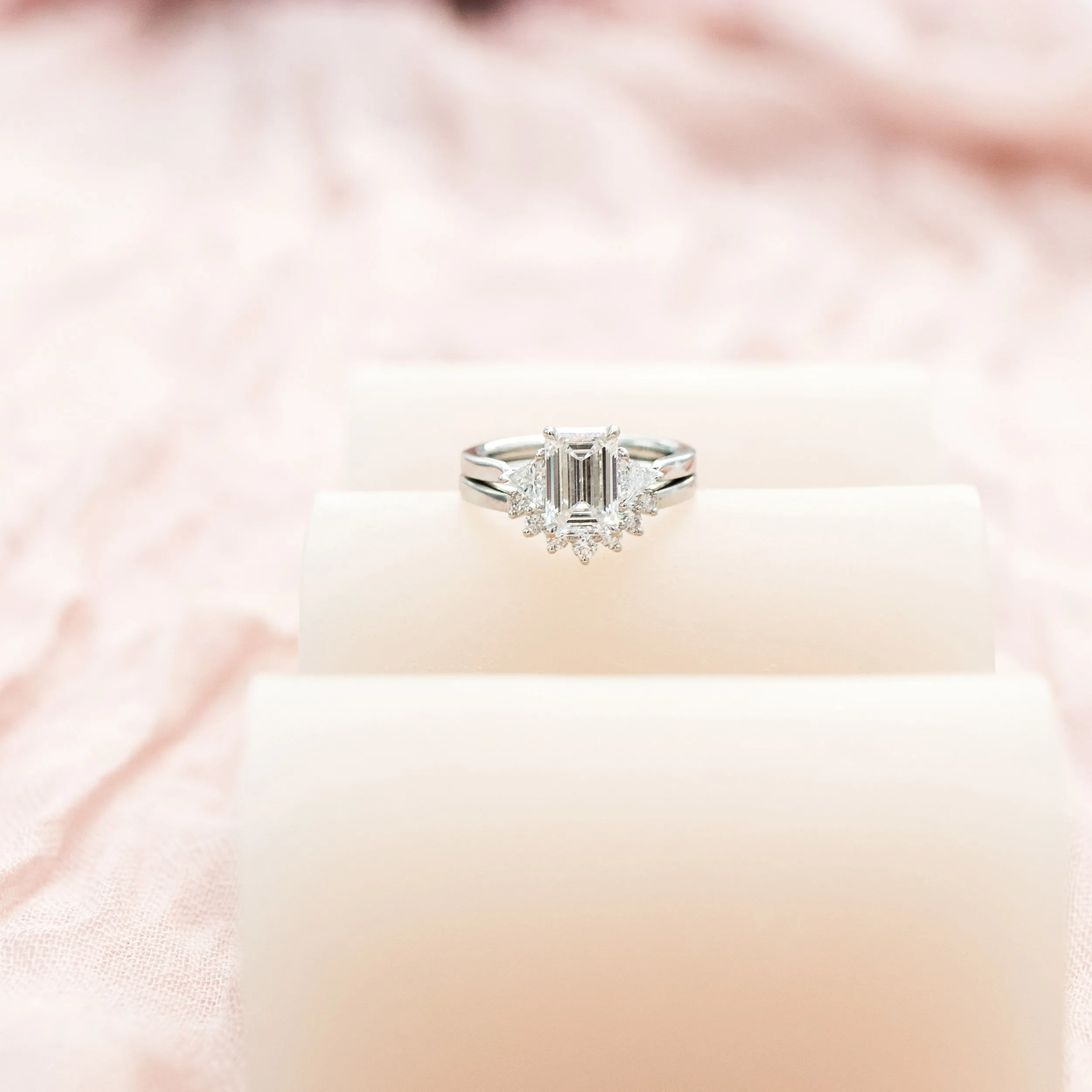 platinum 3 stone engagement ring with 2.25ct emerald cut center stone and trillion side stones with nesting wedding band ada diamonds design ad 466 and ad 258