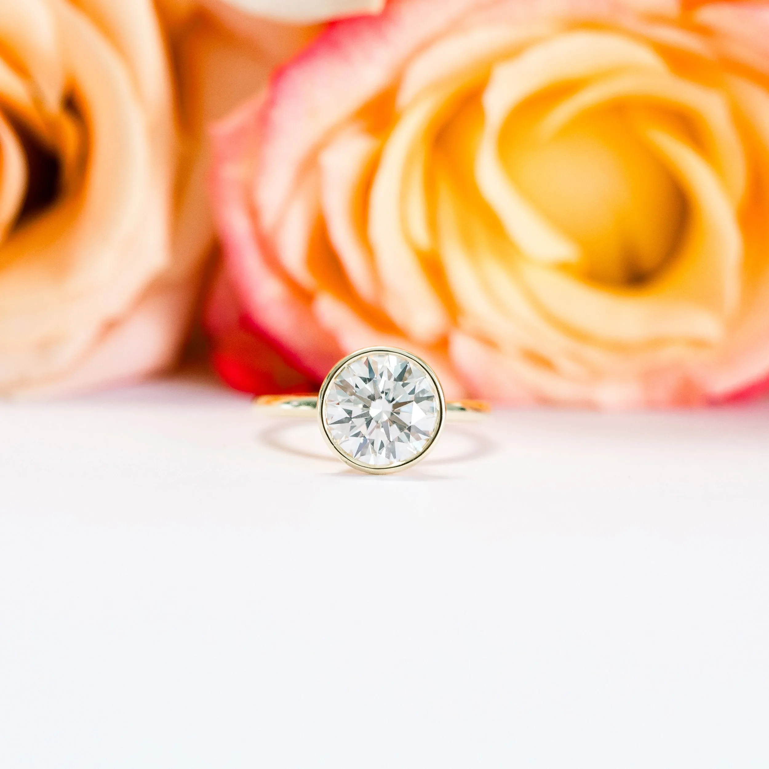 Ada Diamonds Design 148 Lab Diamond Bezel Solitaire Engagement Ring Artistic Shot In Yellow Gold AD148