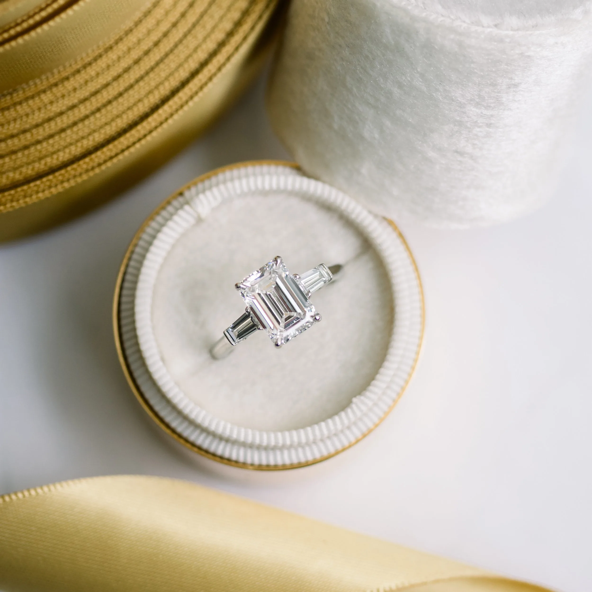platinum emerald cut and baguette three stone lab diamond engagement ring