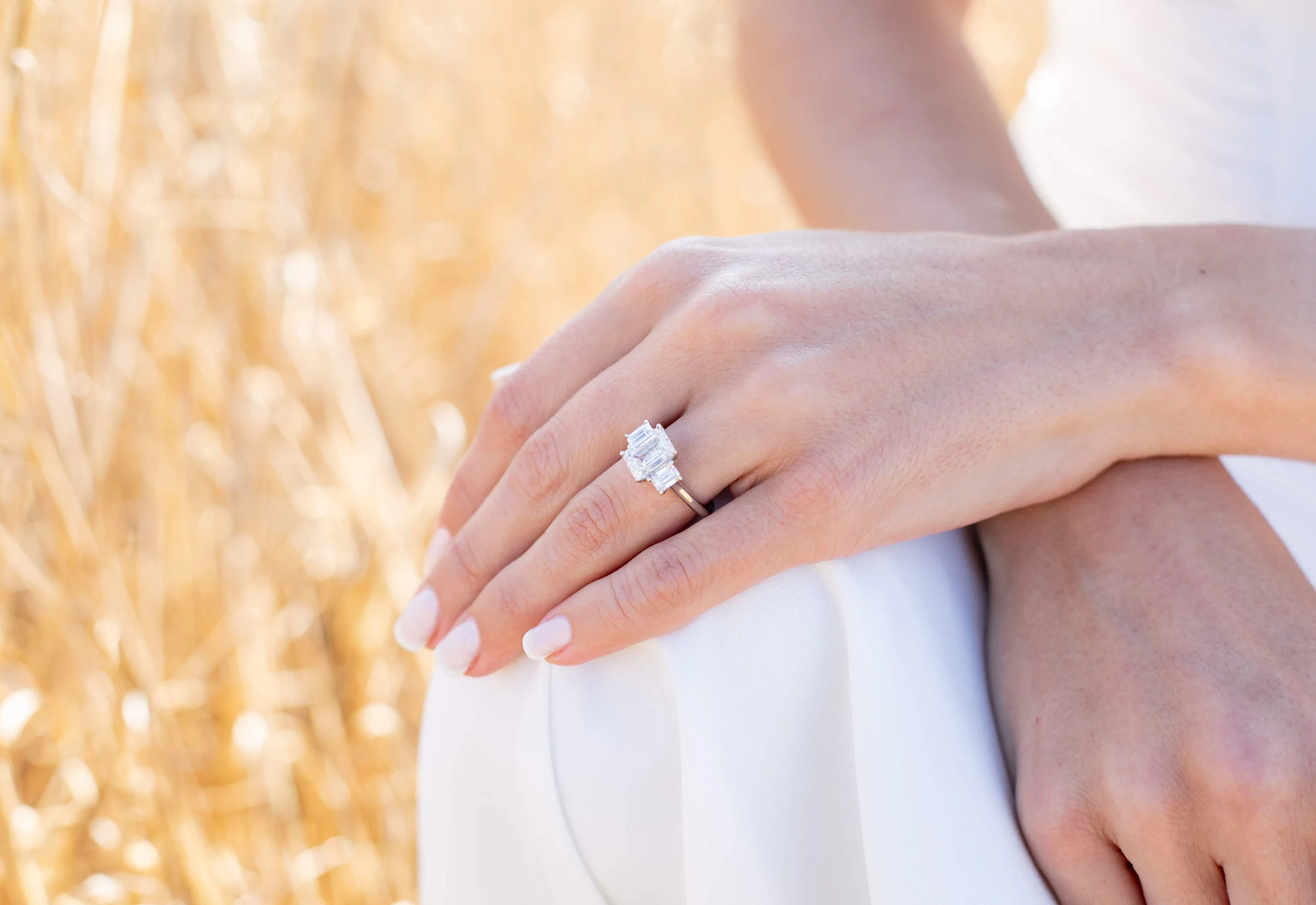 Platinum Emerald Three Stone Diamond Engagement Ring featuring Hand Selected 3.0 Carat Lab Created Diamonds (Profile View)