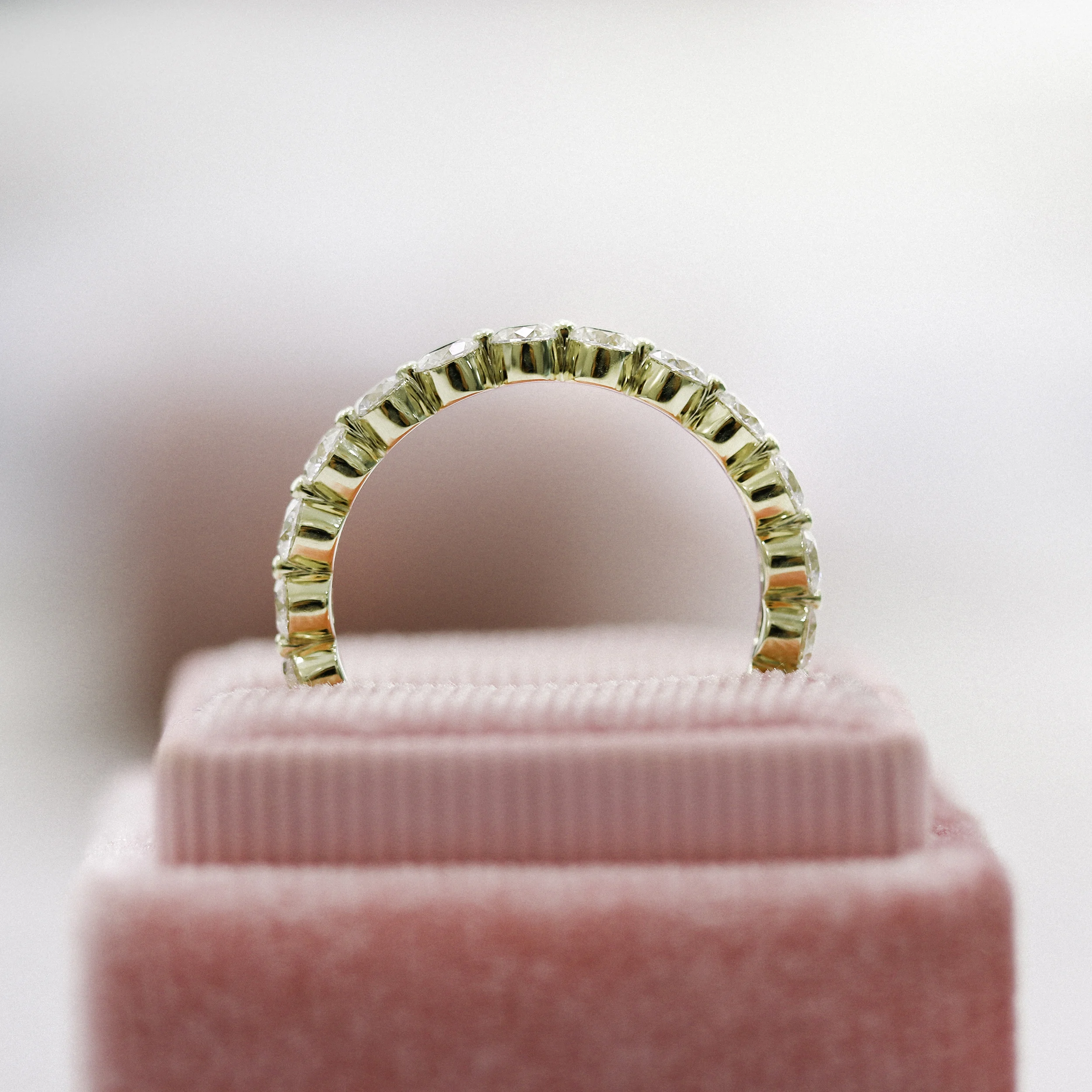 18k Yellow Gold 2ctw Shared Prong Round Diamond Eternity Band in 18k Yellow Gold featuring Hand Selected 2.0 ct Round Man Made Diamonds (Profile View)