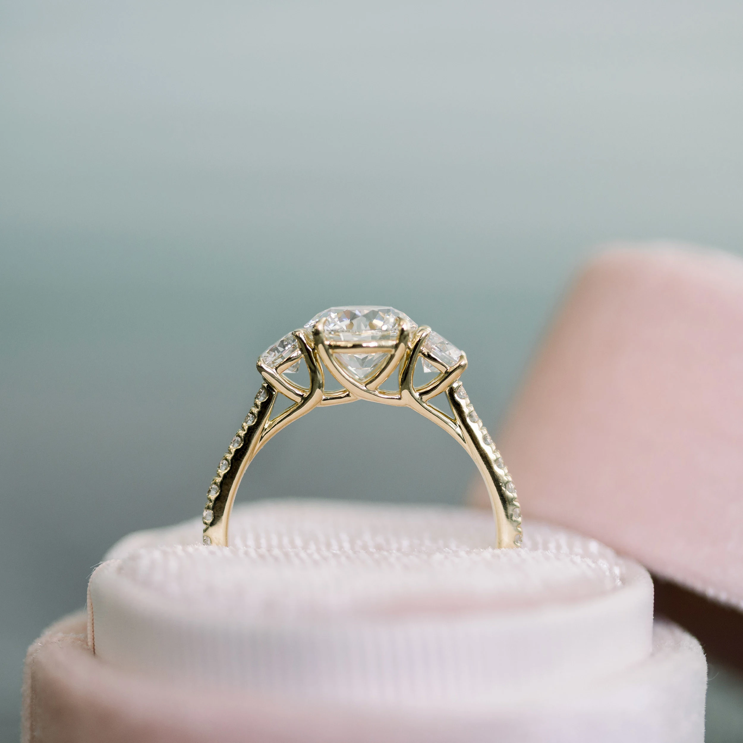 Yellow Gold Round Three Stone Pavé Diamond Engagement Ring featuring High Quality 3.0 Carat Diamonds (Profile View)