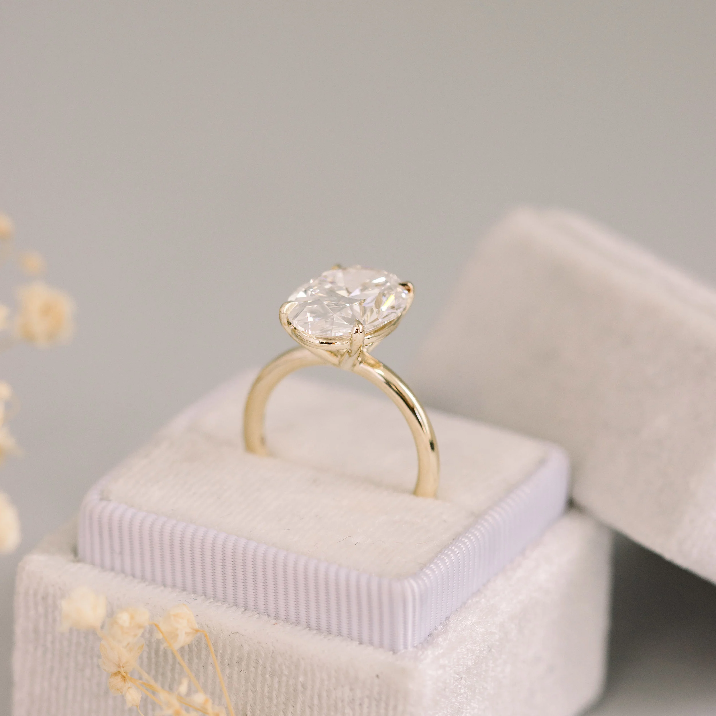 4.75 Carat Synthetic Diamonds set in Yellow Gold Oval Petite Four Prong Solitaire (Profile View)