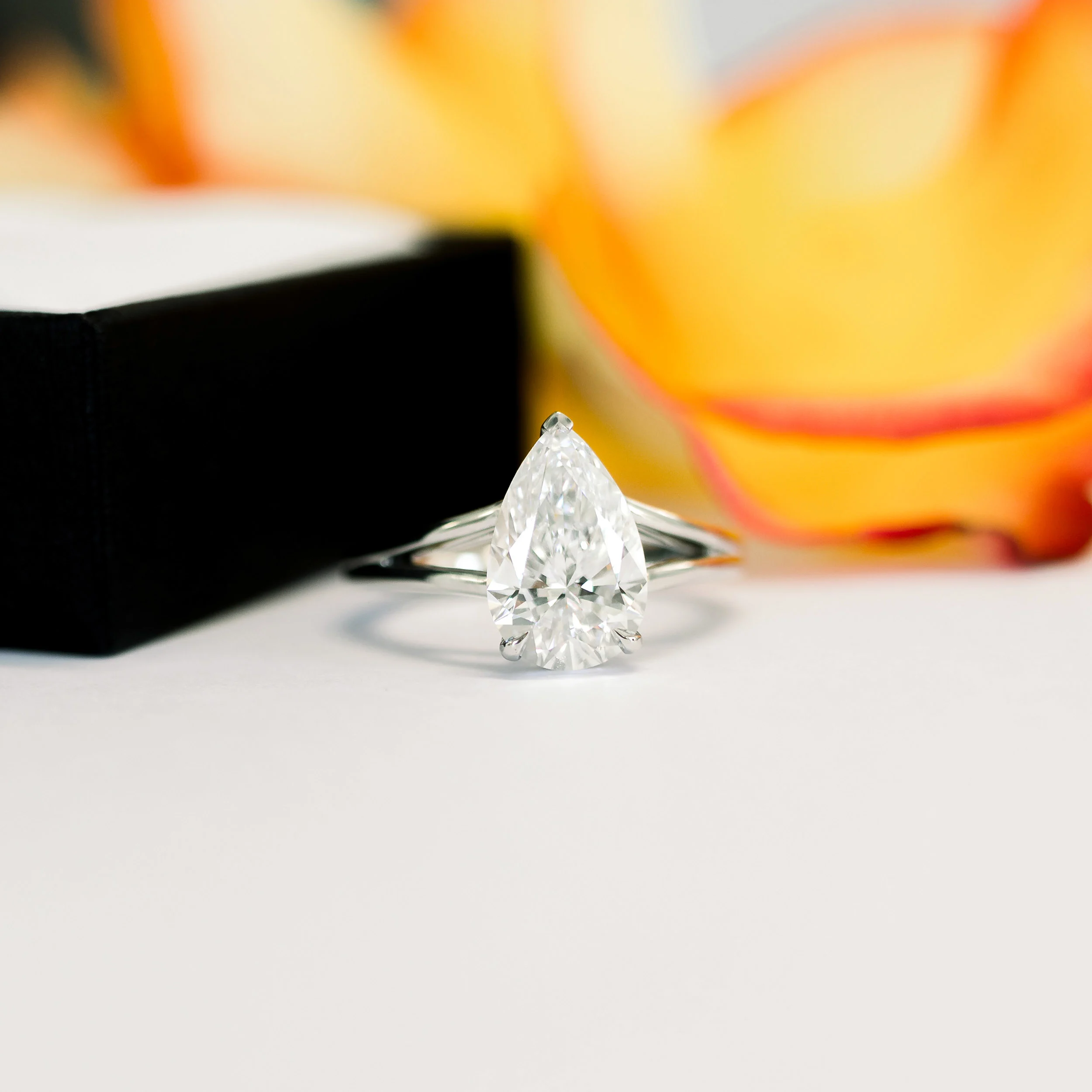 Platinum Pear Split Shank Solitaire featuring Exceptional Quality 2.0 ctw Man Made Diamonds (Main View)
