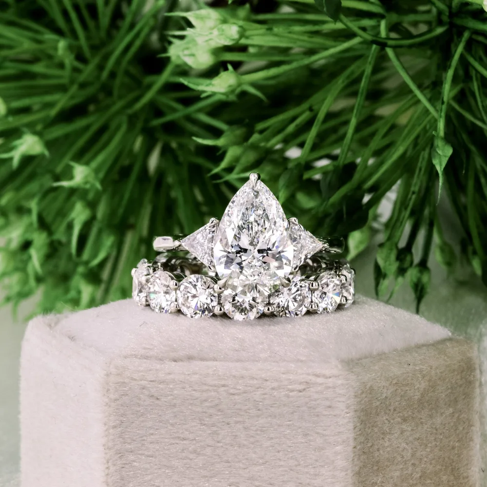 platinum pear and trillion three stone lab diamond engagement ring with prong set lab diamond eternity band ada diamonds design ad 081 and ad 469
