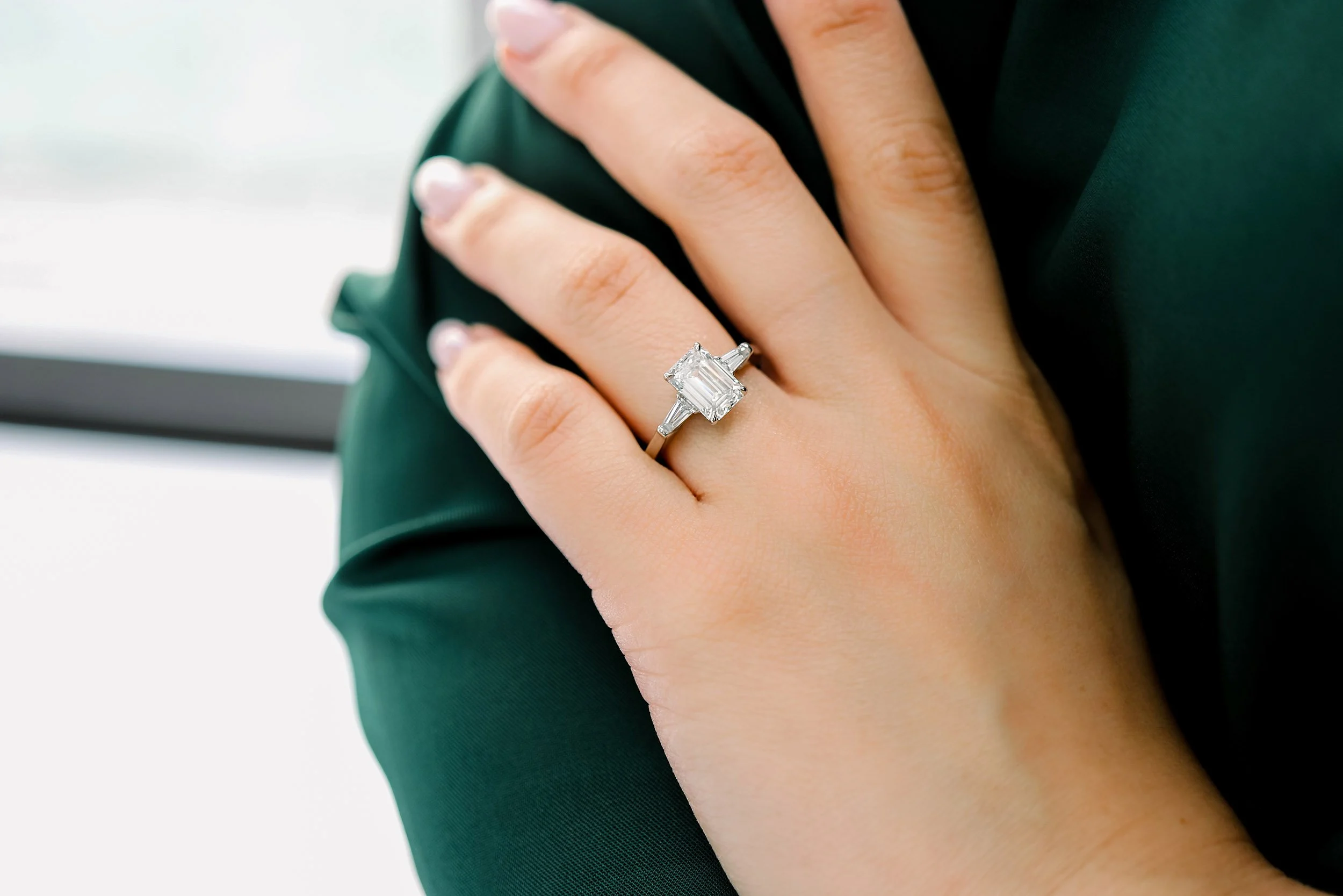lab diamond three stone setting with emerald and baguettes
