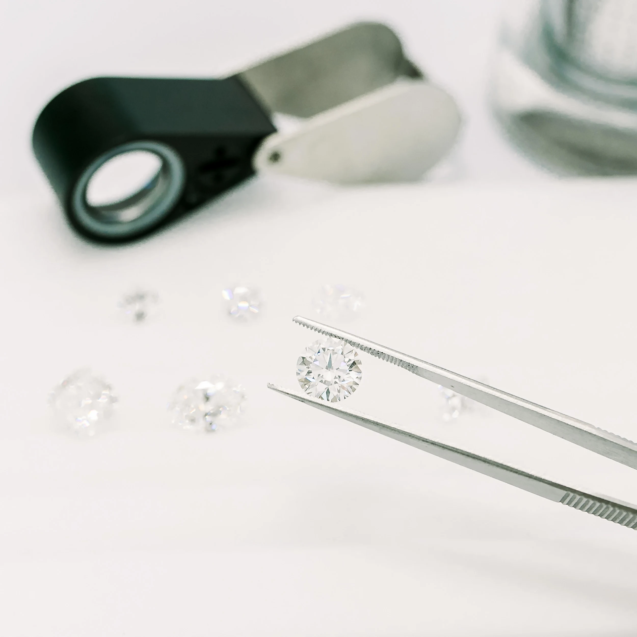 Loose lab diamonds shown in tweezers