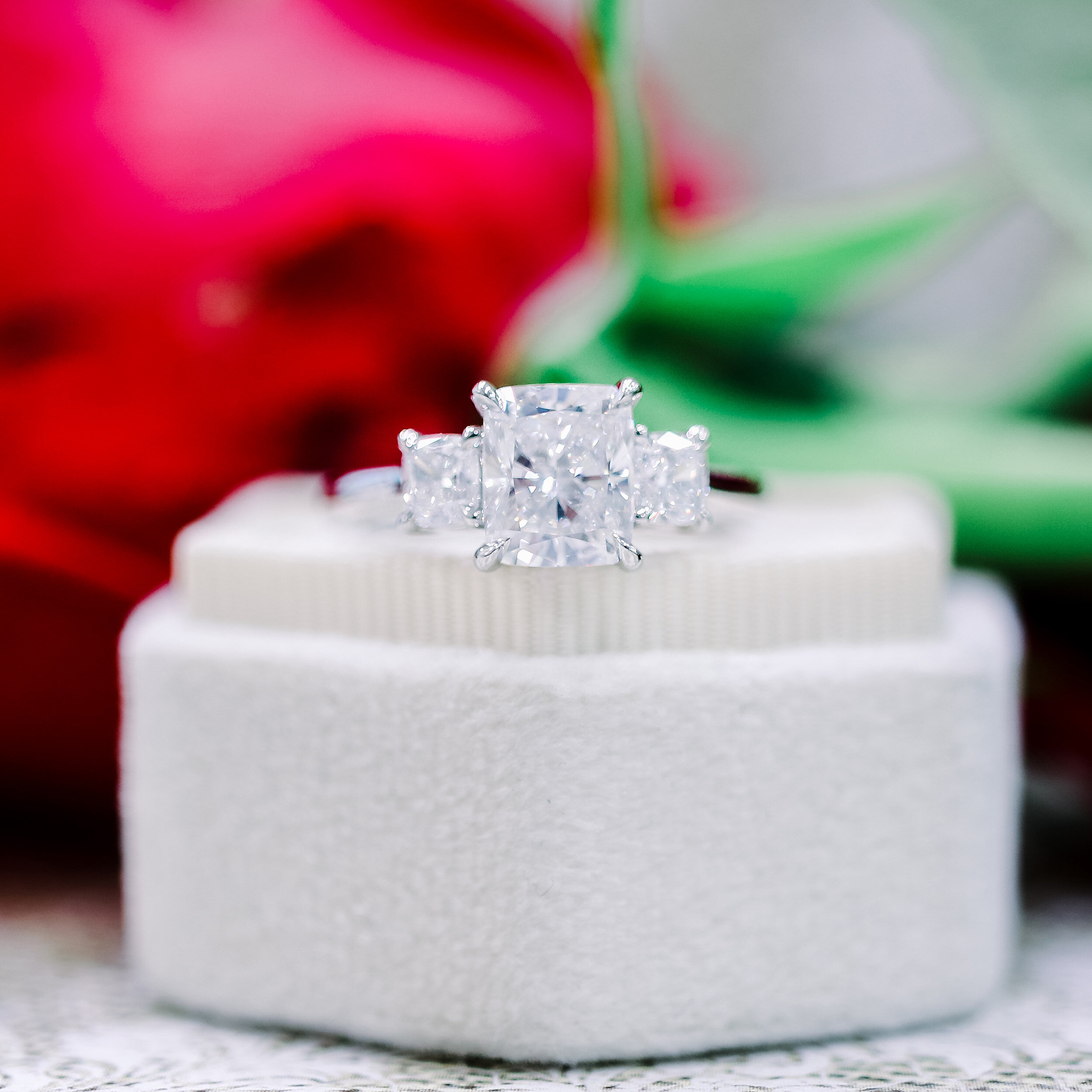 Cushion cut three on sale stone engagement rings