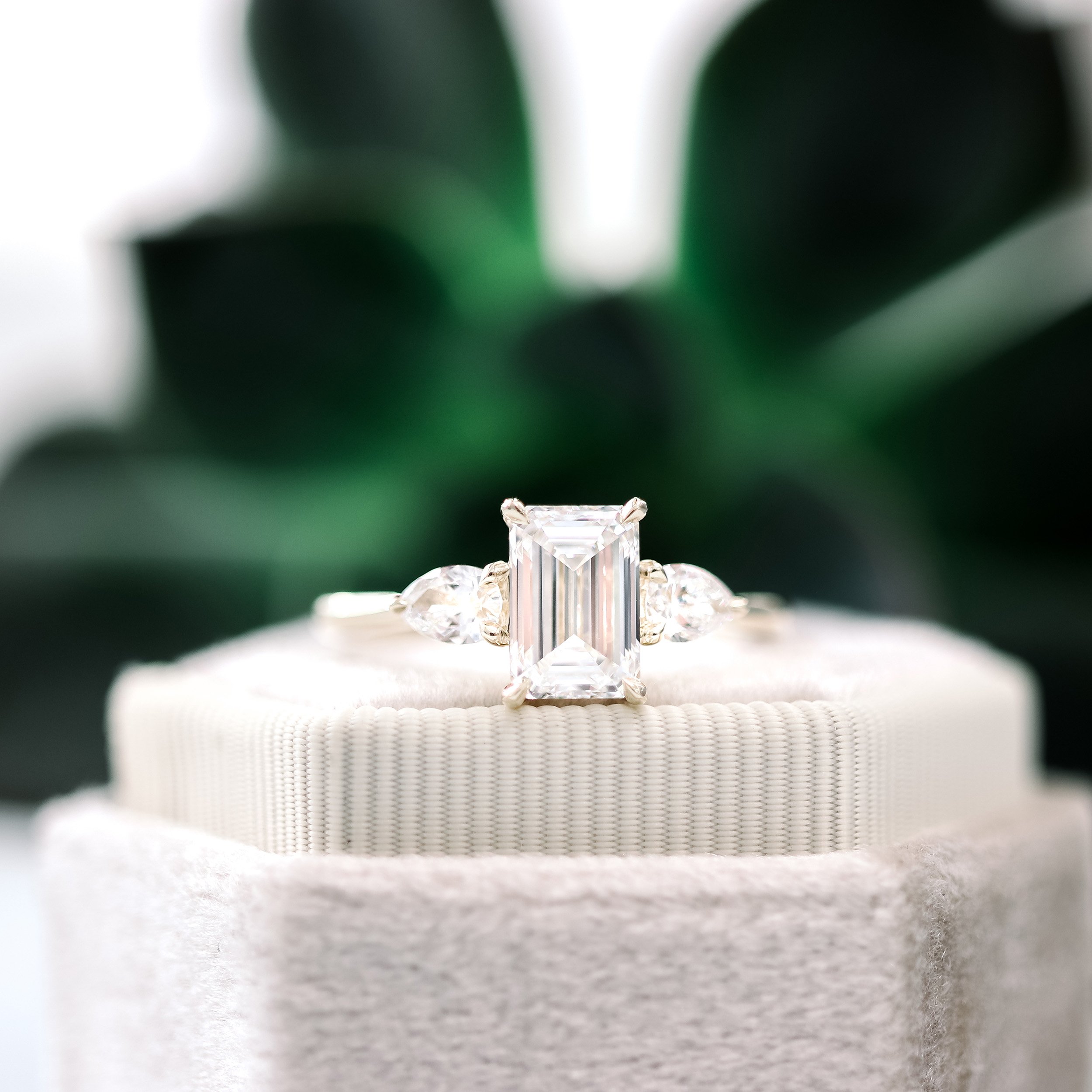 Emerald cut with hot sale pear side stones