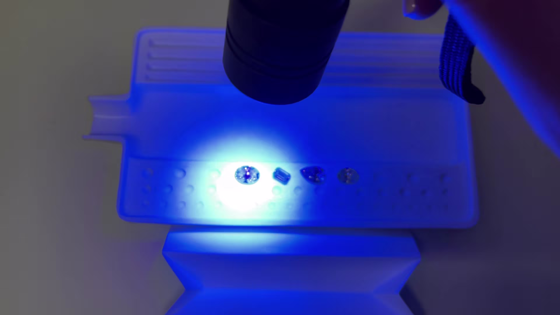 Unusual gray HPHT diamond with growth tubes visible under shortwave UV light